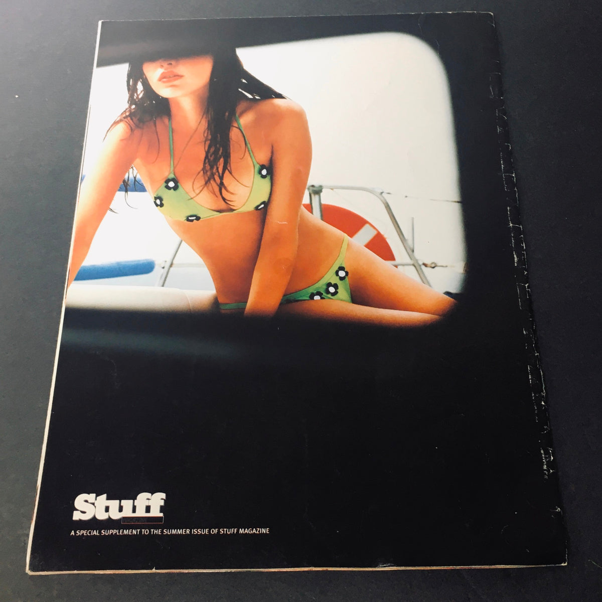 Back cover of Stuff For Him Magazine 2001 with a model in a polka-dotted bikini, highlighting the vintage appeal and summer themes prevalent in early 2000s magazine aesthetics.