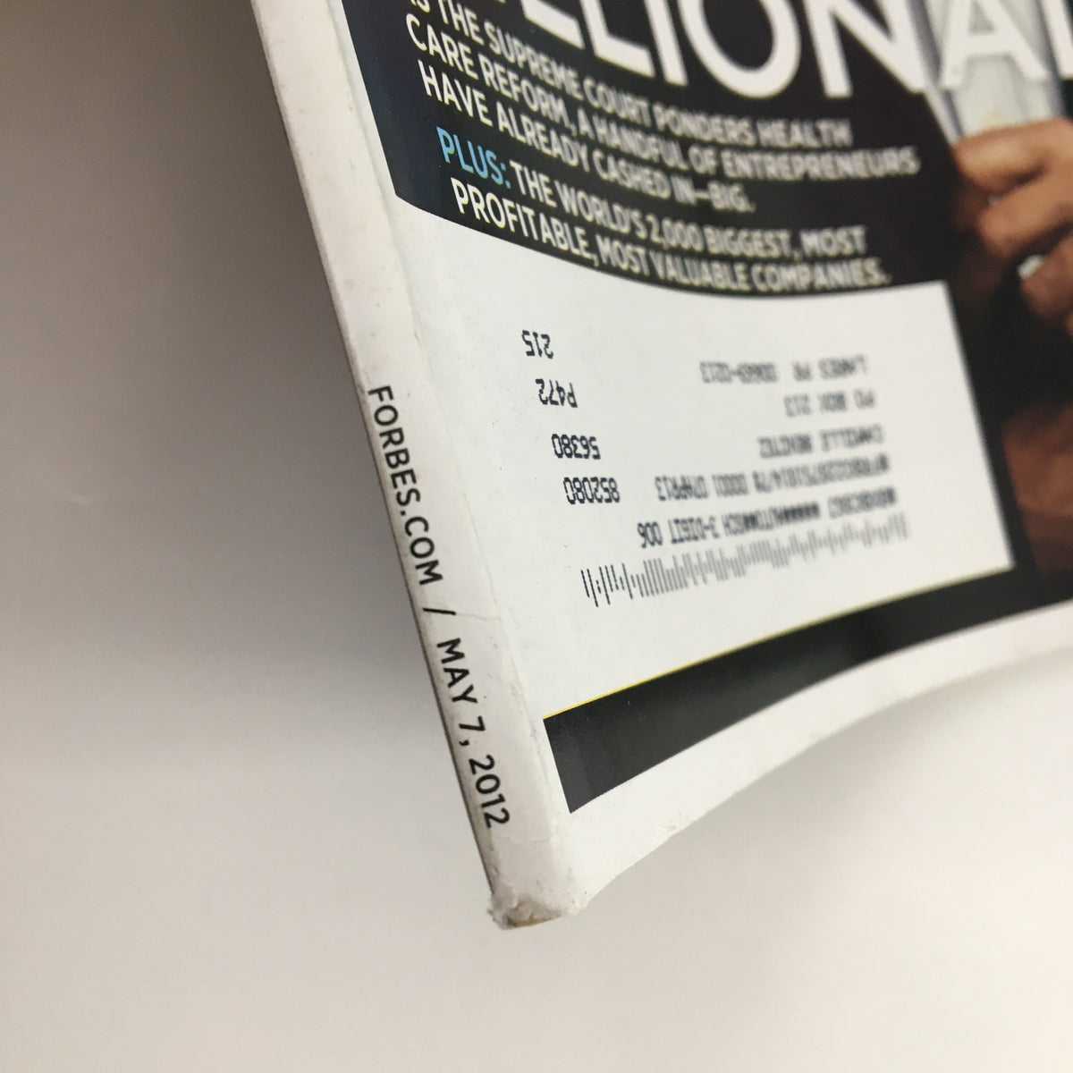 Close-up shot of the spine of Forbes Magazine May 7, 2012, displaying the date and minor wear typical of vintage collectibles.