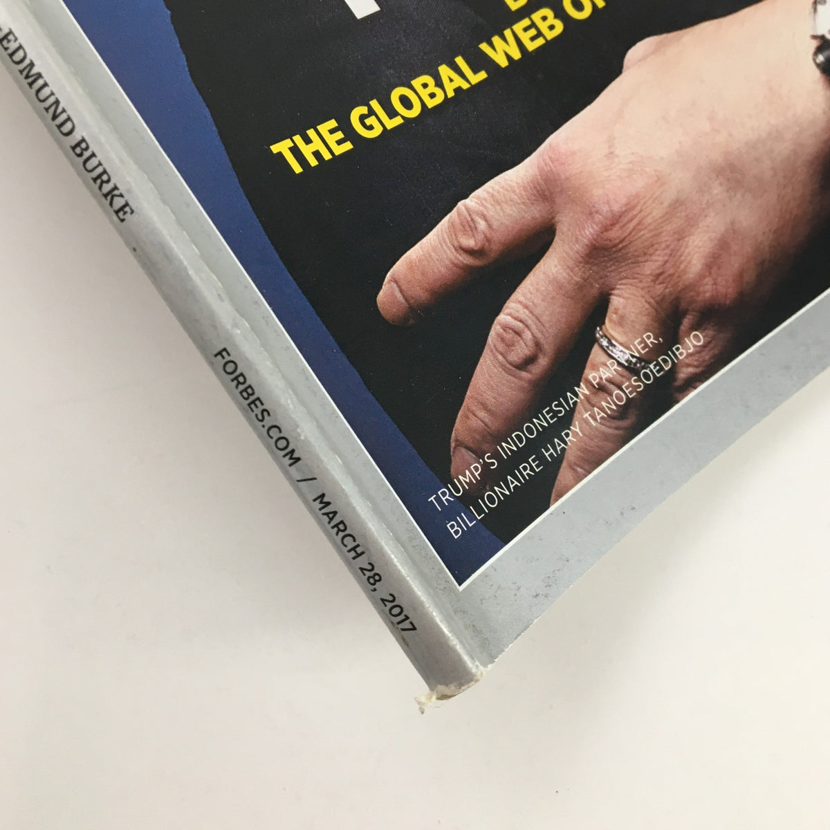 Close-up of the side of Forbes Magazine March 28 2017 with visible date and details about the edition's focus on Donald Trump and wealth.