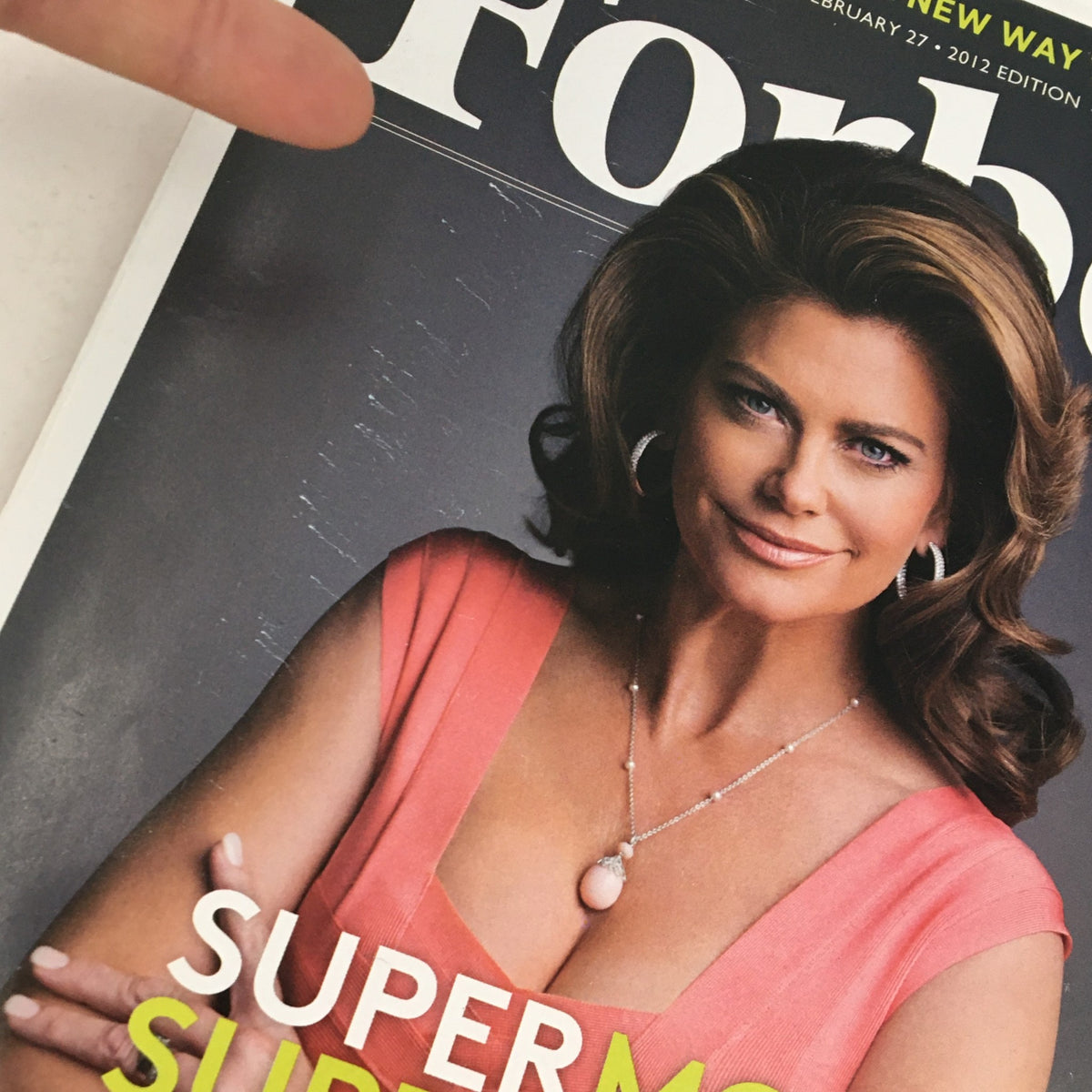 Close-up of the Forbes Magazine cover from February 27, 2012, showcasing Kathy Ireland, emphasizing her glamorous appearance and the title 'Supermodel Supermogu'l.