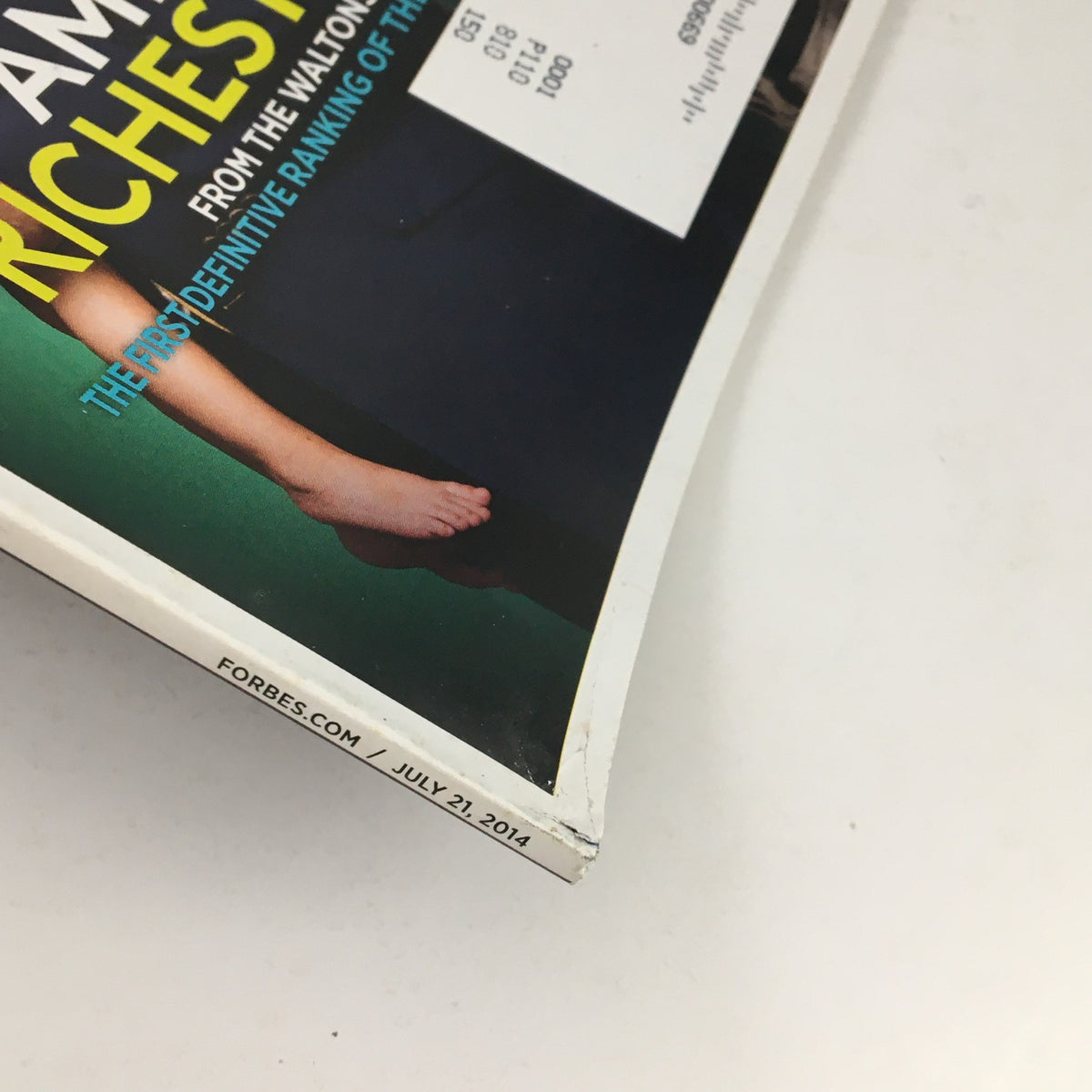 Close-up of the edge of Forbes Magazine from July 21, 2014, showcasing the title 'America's Richest Families' and details of wear typical for its age. An essential item for those interested in historical magazines.