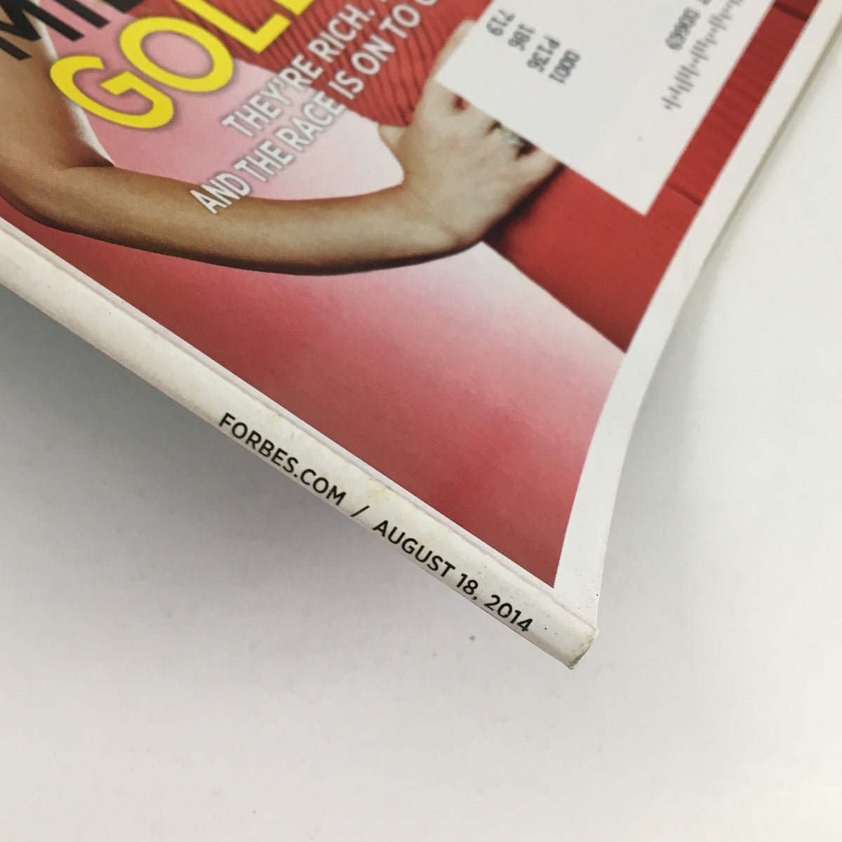 Close-up view of the bottom edge of Forbes Magazine, August 18, 2014, prominently showing the date and detailing the vintage nature of the publication.