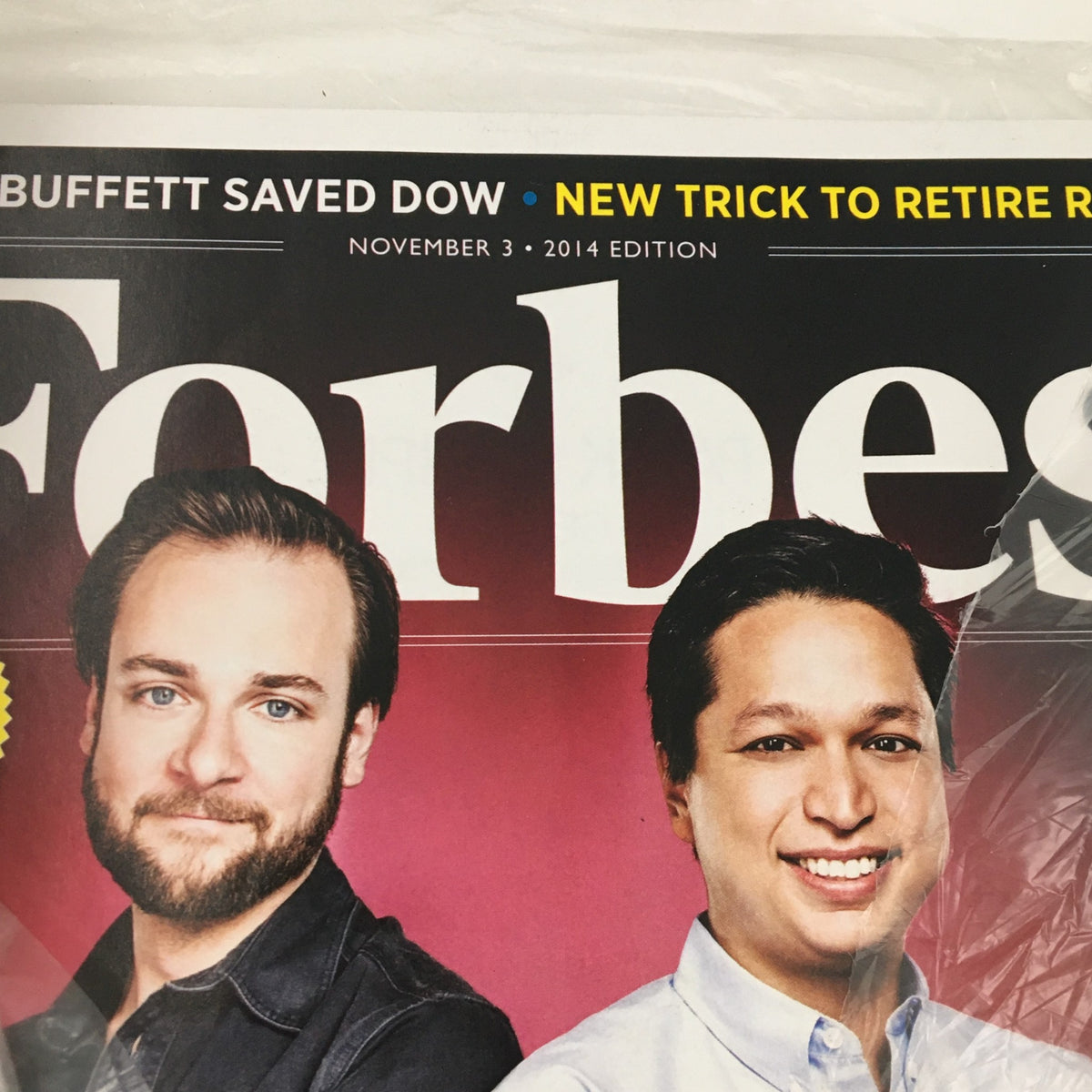 Close-up of Forbes Magazine cover dated November 3, 2014, showcasing Evan Sharp and Ben Silbermann with the phrase 'New Trick to Retire Rich'.