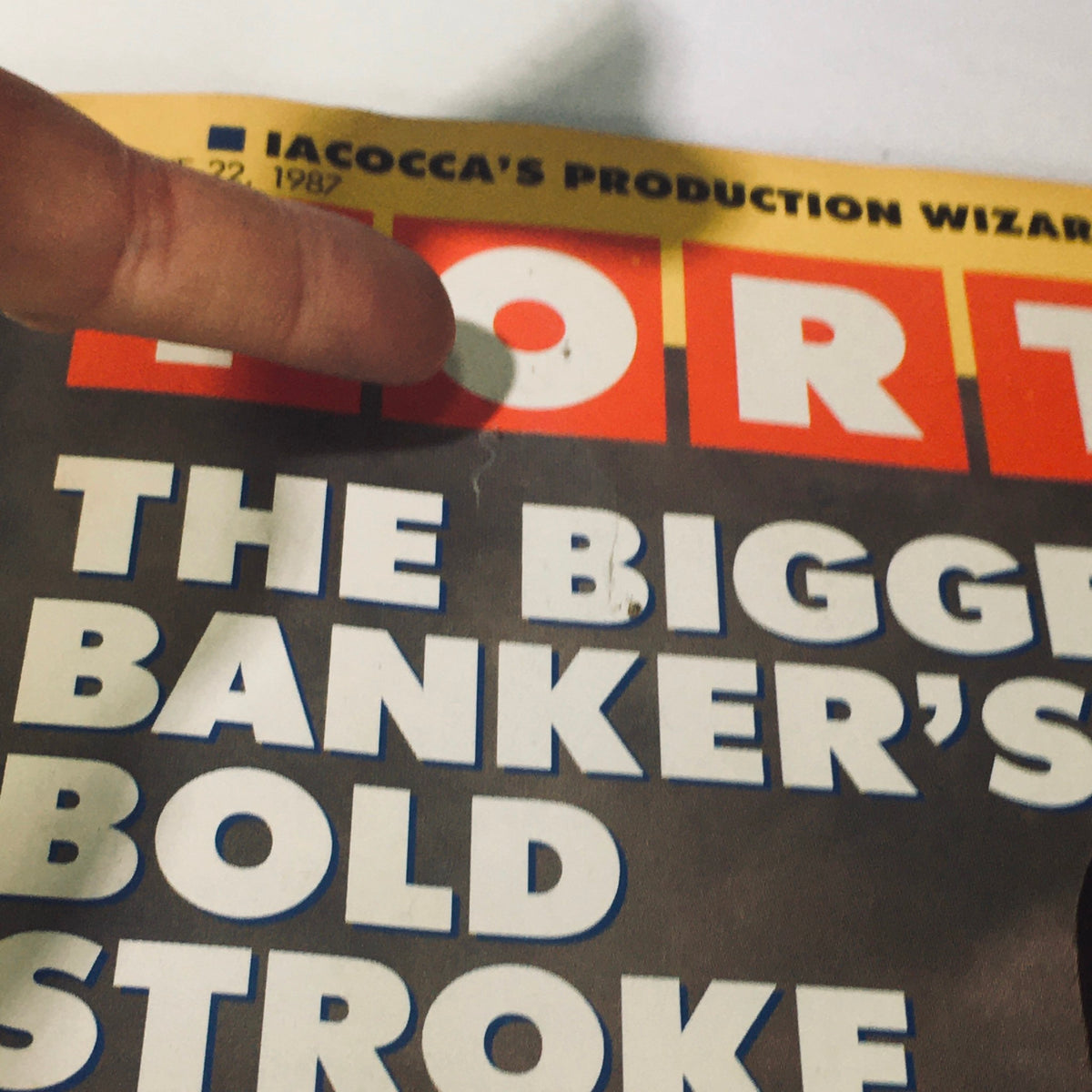 Close-up of the Fortune Magazine June 22, 1987 cover highlighting the title 'The Biggest Banker's Bold Stroke' and focusing on the word 'FORTUNE' with a finger pointing to the cover.