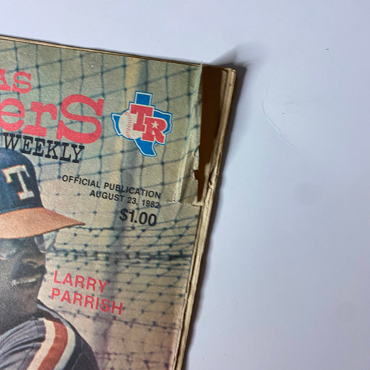 Close-up view of Texas Rangers Weekly Magazine from August 23, 1982, highlighting the cover with Larry Parrish and an official publication label.