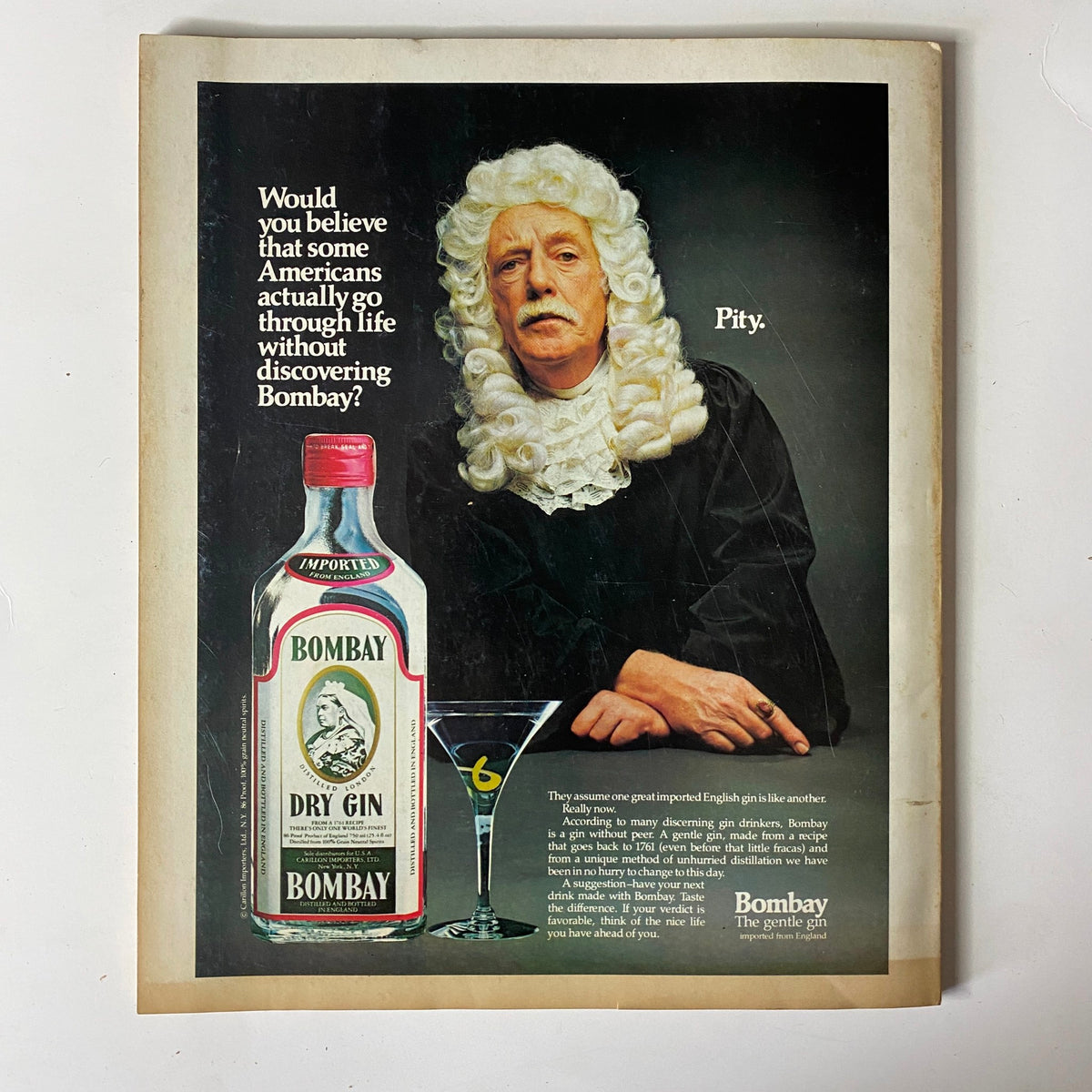 Advertisement from Fortune Magazine, October 20, 1980, promoting Bombay Dry Gin, featuring a man in a wig with a martini glass, with the caption questioning life without discovering Bombay.