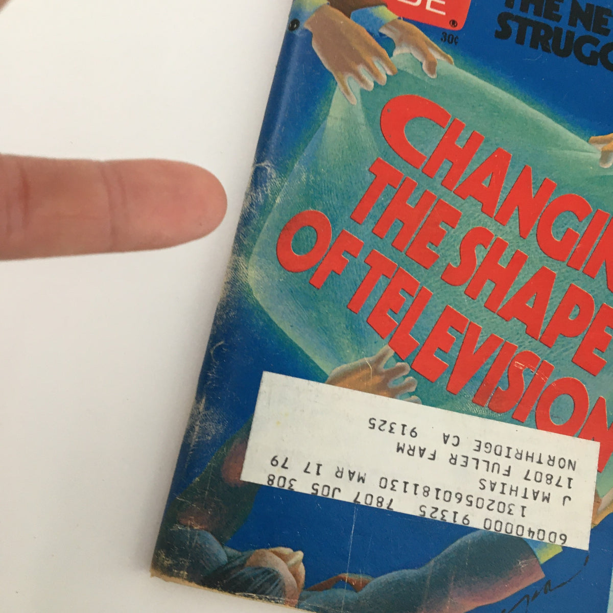 Close-up of the cover of TV Guide Magazine April 22, 1978, highlighting the theme 'Changing The Shape of Television', with details such as hands and a label partially covering the bottom.