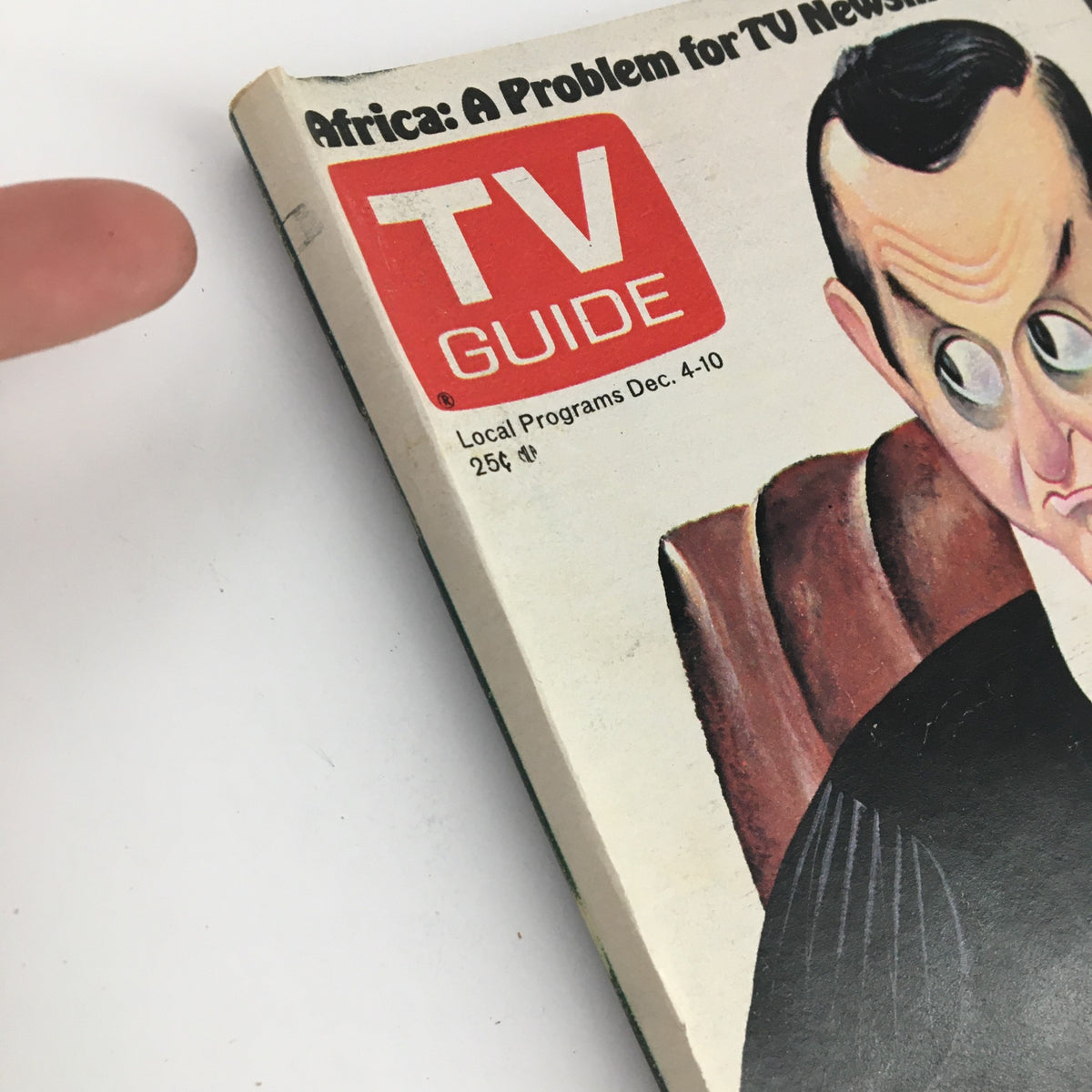 Cover of TV Guide Magazine dated December 4, 1976, featuring an illustration titled 'Africa: A Problem for TV Newsmen', showcasing the iconic TV Guide logo and highlighting local programs for the week.