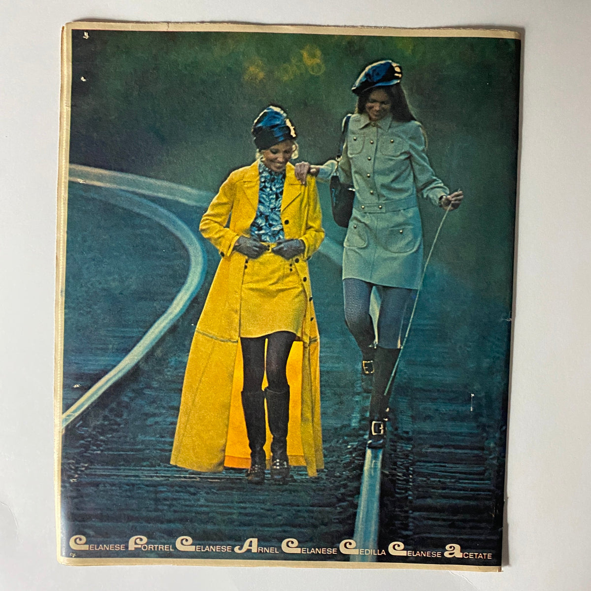 The New York Times Magazine January 4 1970 page showing models in trendy Celanese attire, one in a yellow coat and another in a stylish ensemble, walking along a railway.