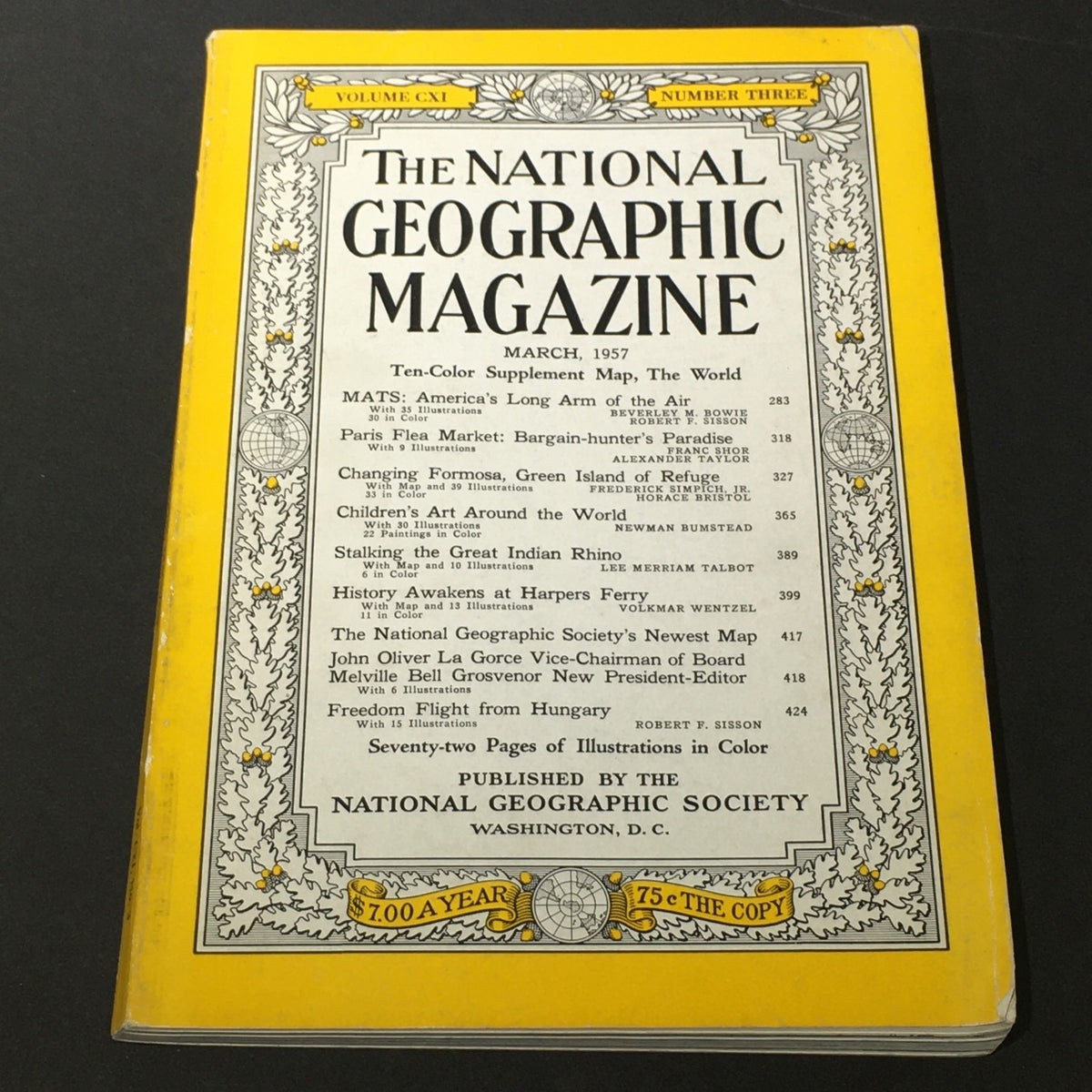 Vintage National Geographic Magazine from March 1957 featuring a 10-color supplement world map on the cover. The magazine showcases its iconic yellow border and contains various articles along with vibrant illustrations, making it a valuable collectible for history and geography enthusiasts.