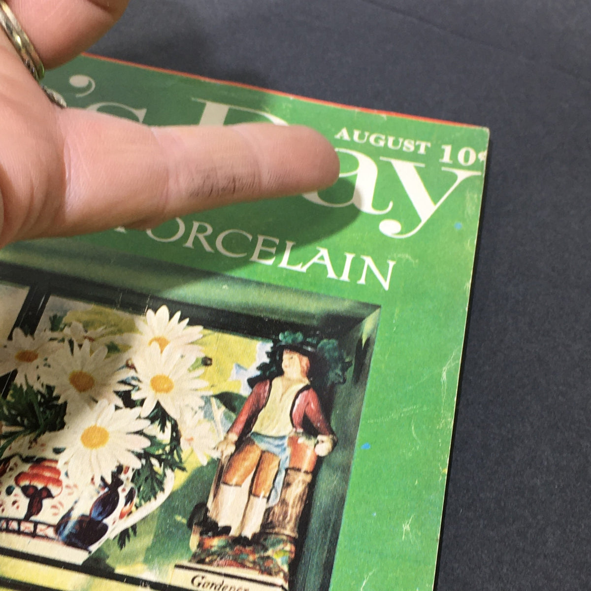 Cover of VTG Woman's Day Magazine August 1962 featuring a floral design and a pottery figurine, highlighting the topic "Dictionary of Pottery and Porcelain."