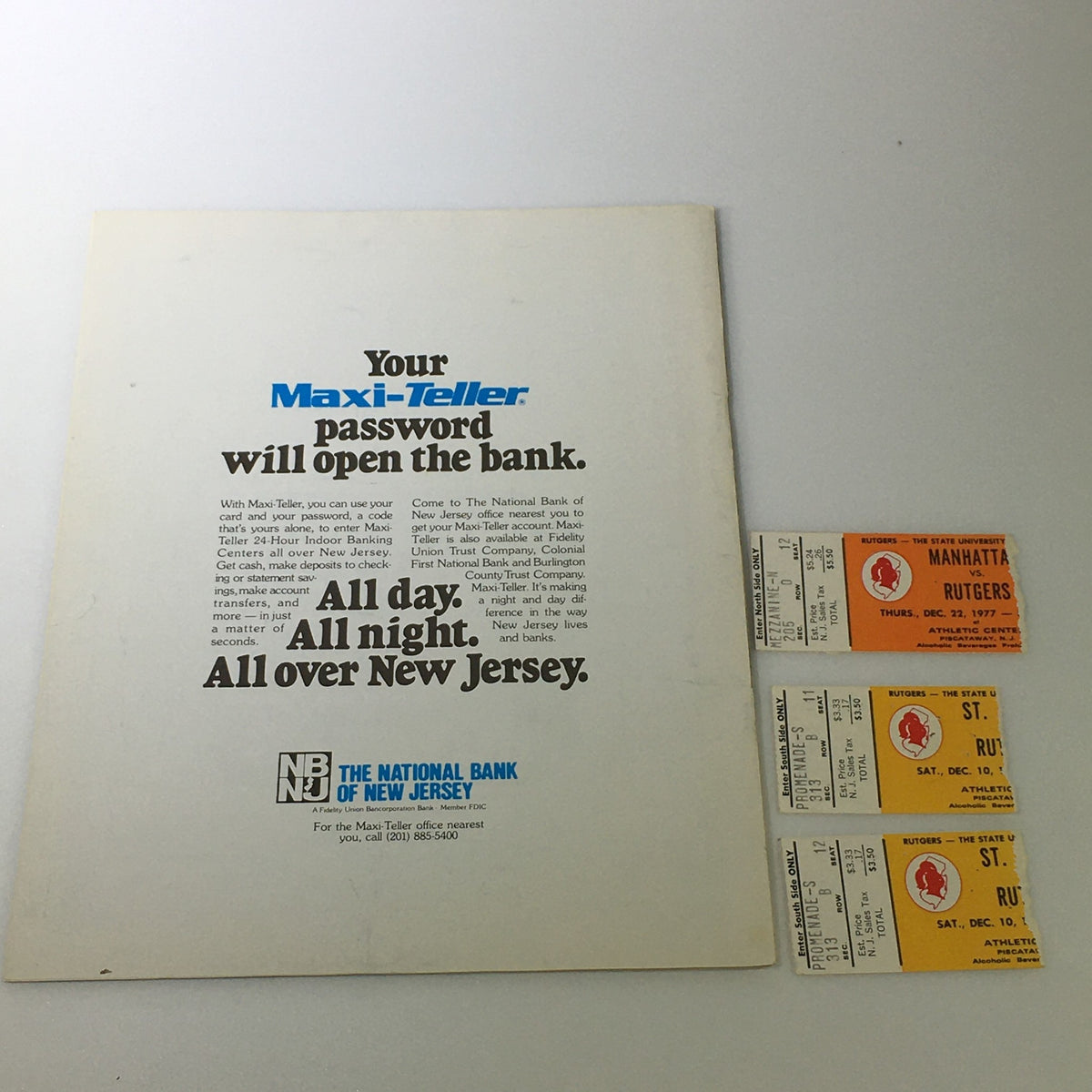 Vintage NCAA Rutgers Scarlet Knights Basketball Magazine December 7-8 1978, featuring original newspaper advertisements and three game tickets from 1977, showcasing memorabilia from Rutgers basketball history.