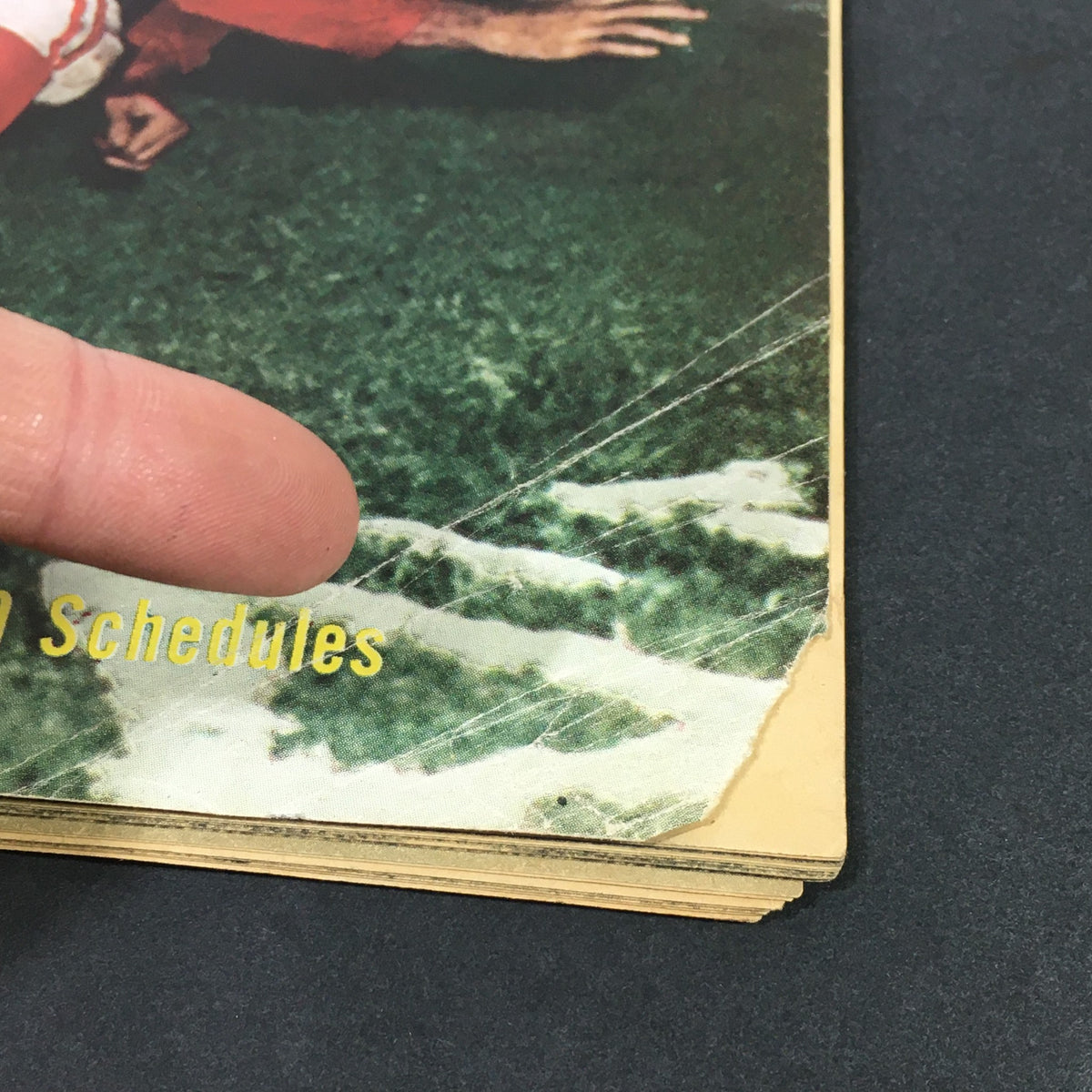 Close-up detail of the cover of VTG Sports Review Pro Football Illustrated Vol. 9 #4 from 1949, highlighting wear and historical features.