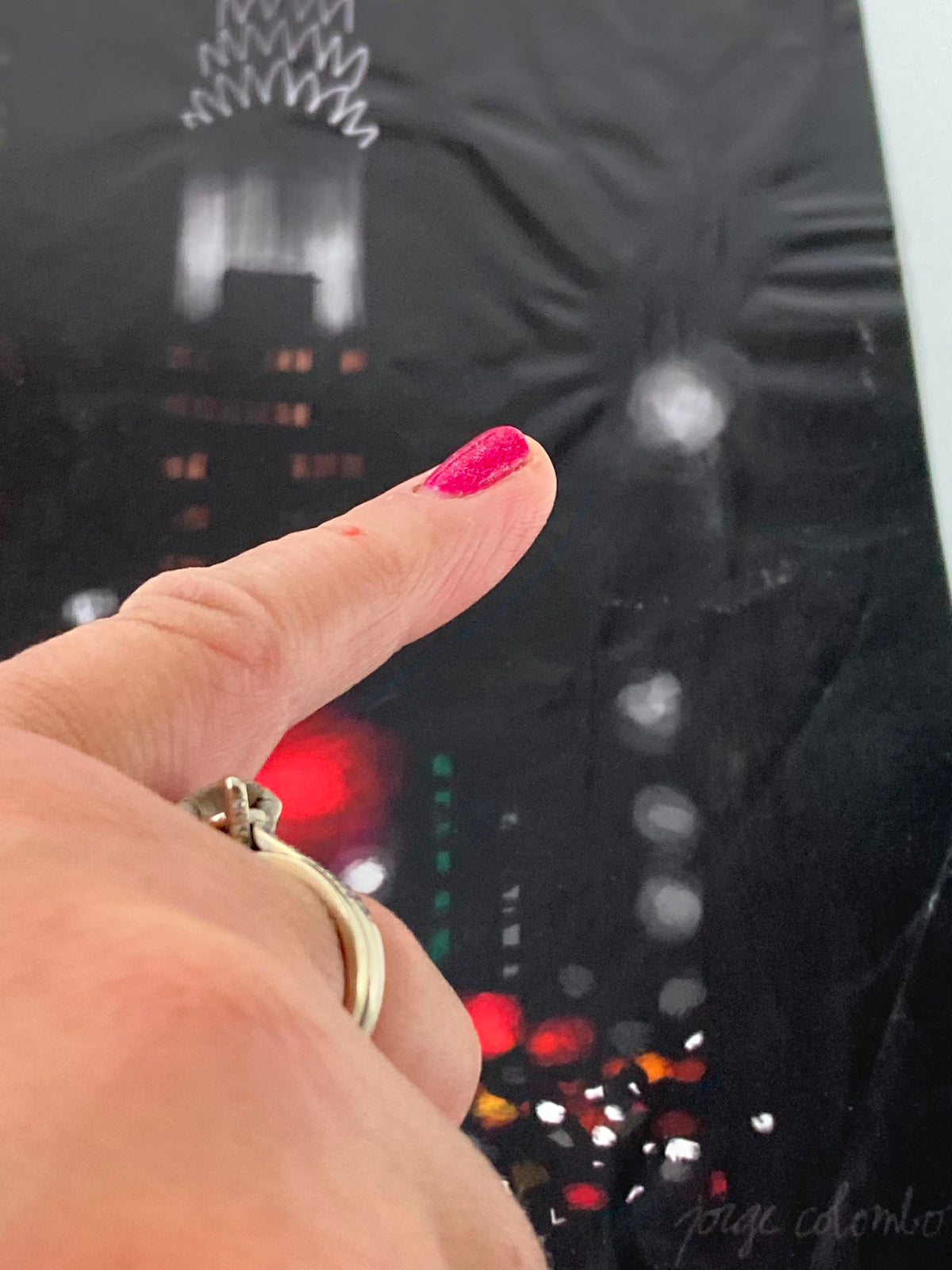 Close-up of The New Yorker November 16 2009 cover titled 'Night Lights' by Jorge Colombo, highlighting a finger pointing at the detailed artwork, showcasing the magazine's unique artistic flair.