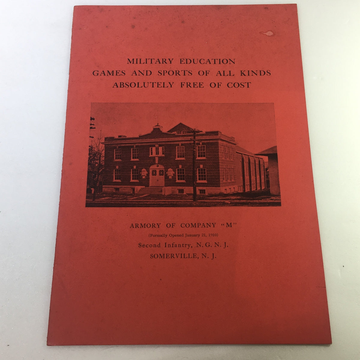 VTG January 21, 1910 Military Education and Sports Armory of Company 'M' vintage cover featuring an image of the armory building in Somerville, NJ. The red cover announces free educational games and sports.