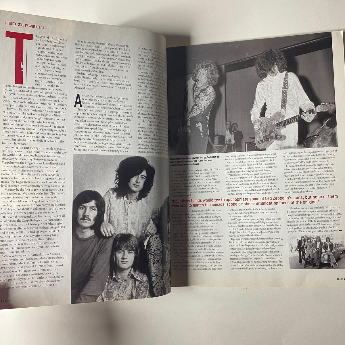Another inside spread from Uncut UK Magazine July 2002 showcasing Led Zeppelin. The text analyzes their influence and features photographs of the band during a live performance.