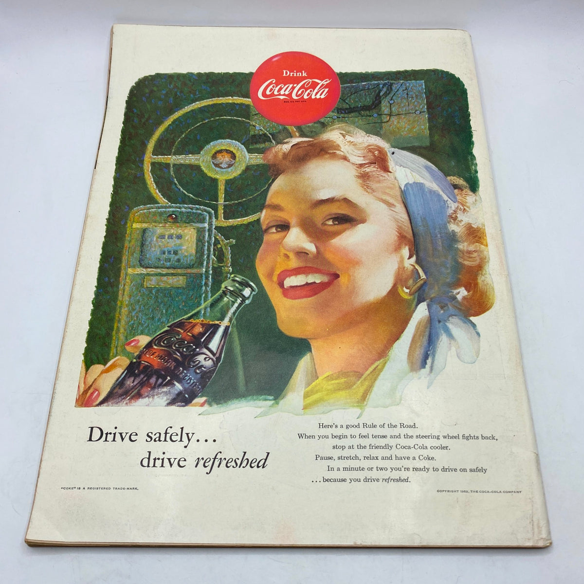 Vintage Coca-Cola advertisement from the 1950s, showcasing a smiling woman with a Coca-Cola bottle, promoting refreshment with a nostalgic charm.