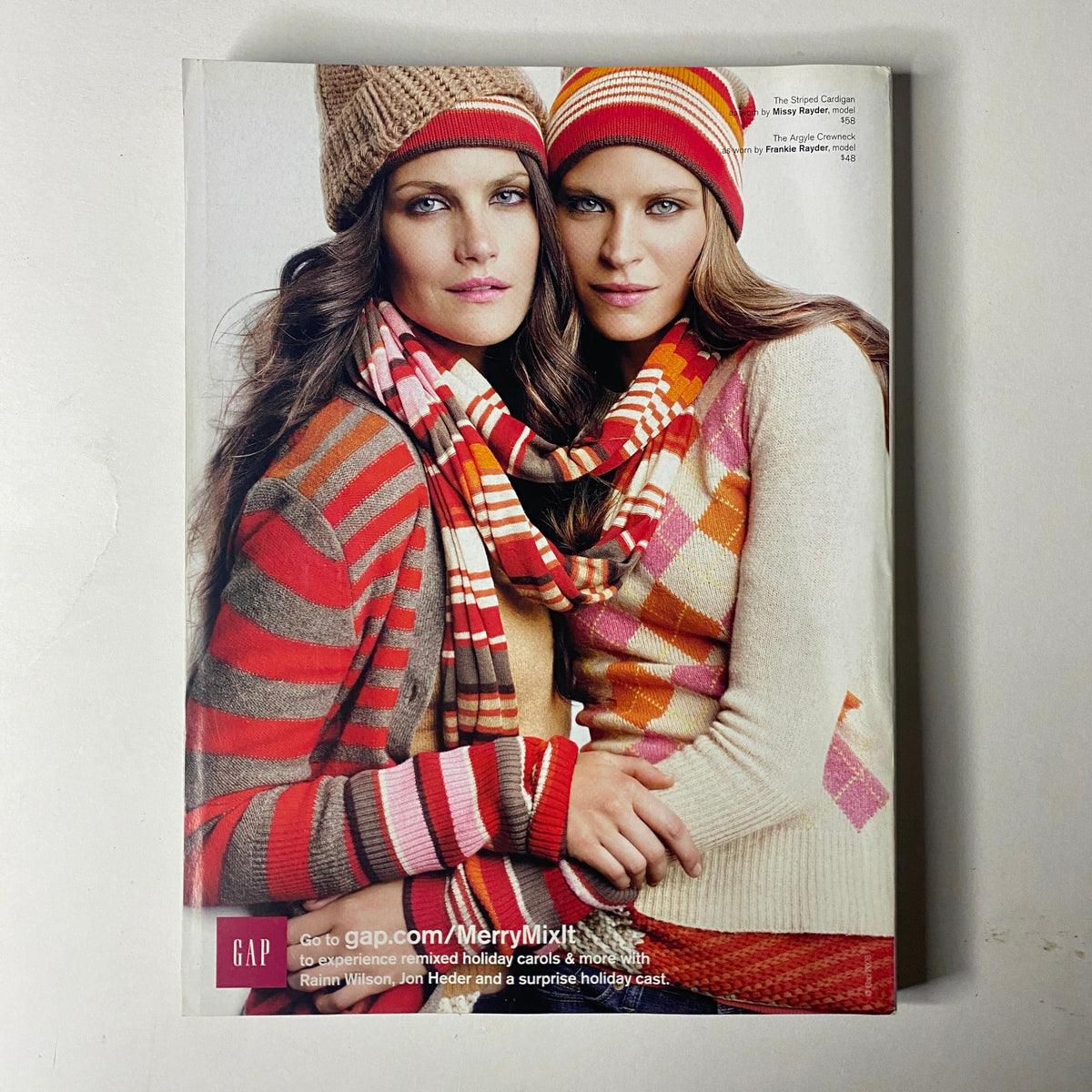 Gap advertisement from Vogue Magazine December 2008, showcasing models in cozy apparel and accessories for the holiday season.