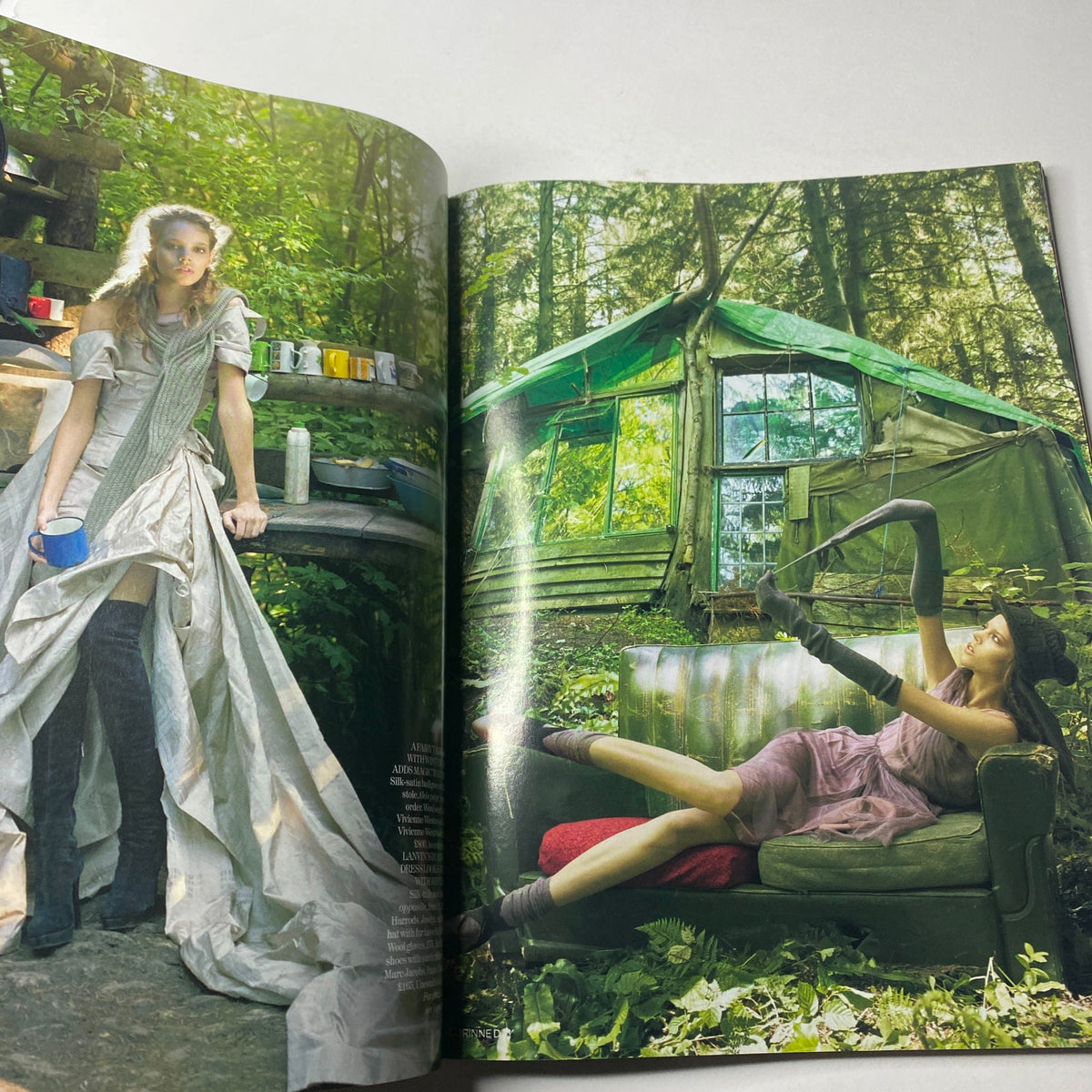 Fashion spread from Vogue British Magazine November 2006 featuring a striking editorial photo of models in a lush forest setting, highlighting creative styling and autumn fashion.