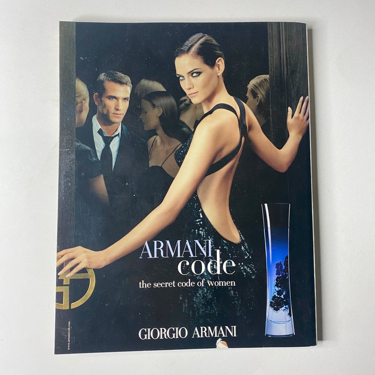 Giorgio Armani advertisement from Vogue British Magazine November 2006 showcasing the fragrance 'ARMANI code' with an elegant model, emphasizing luxury and allure.