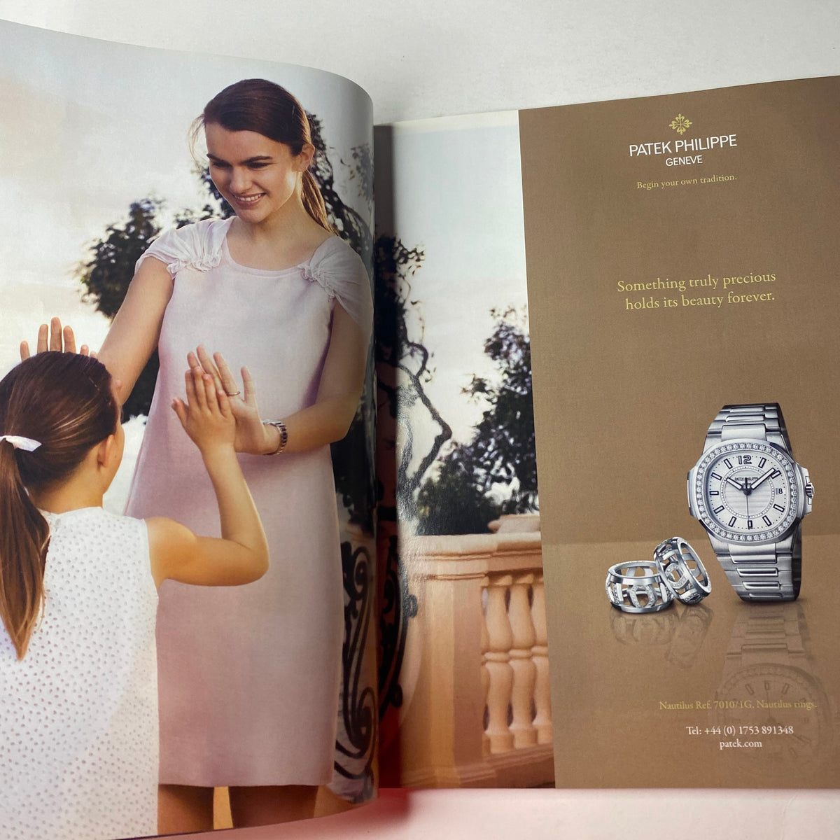 Advertisement page from Vogue British Magazine June 2011 for Patek Philippe, featuring a woman and child with elegant accessories.