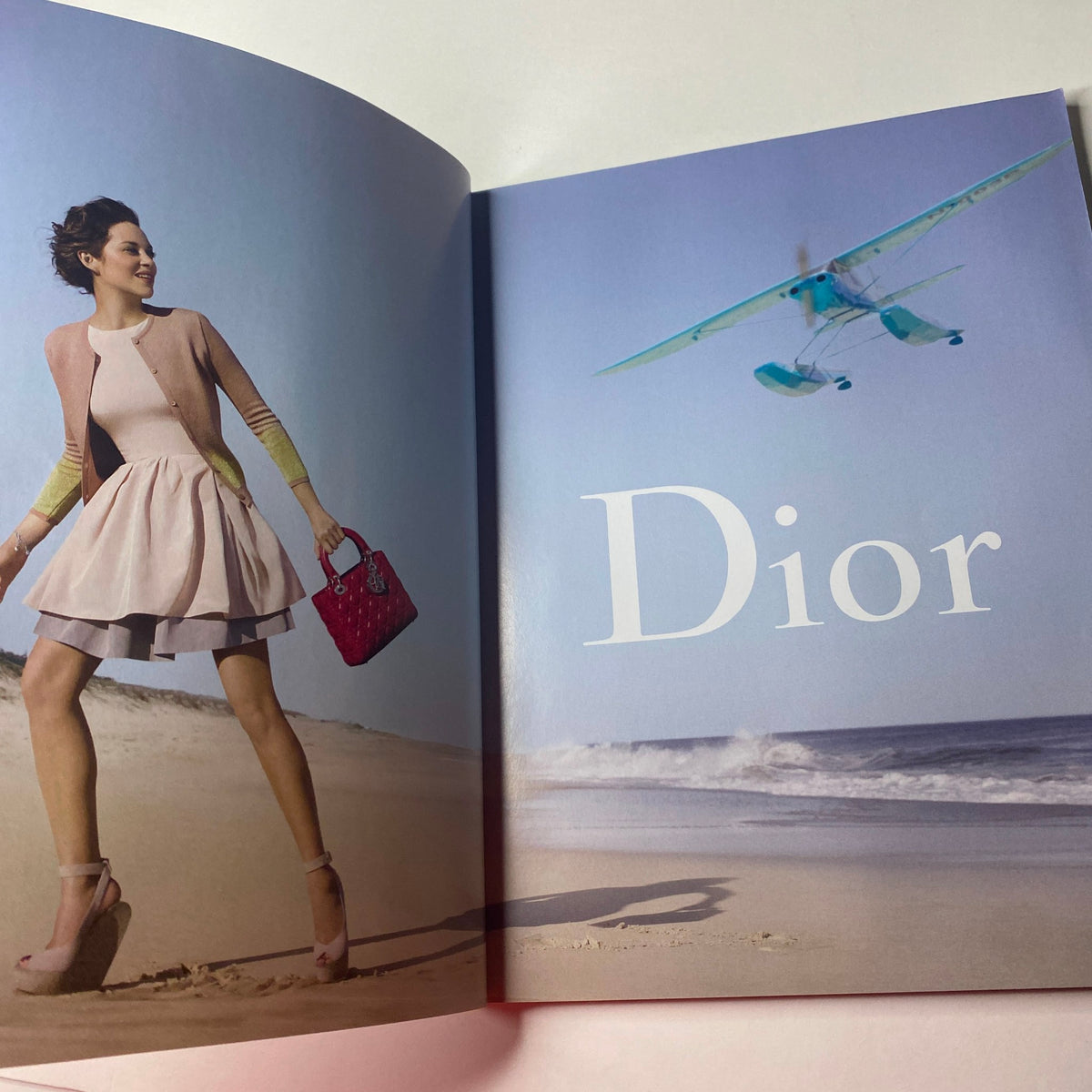 Inside Vogue British Magazine January 2013, presenting a glamorous fashion shot featuring a model in elegant Dior wear on a beach setting.