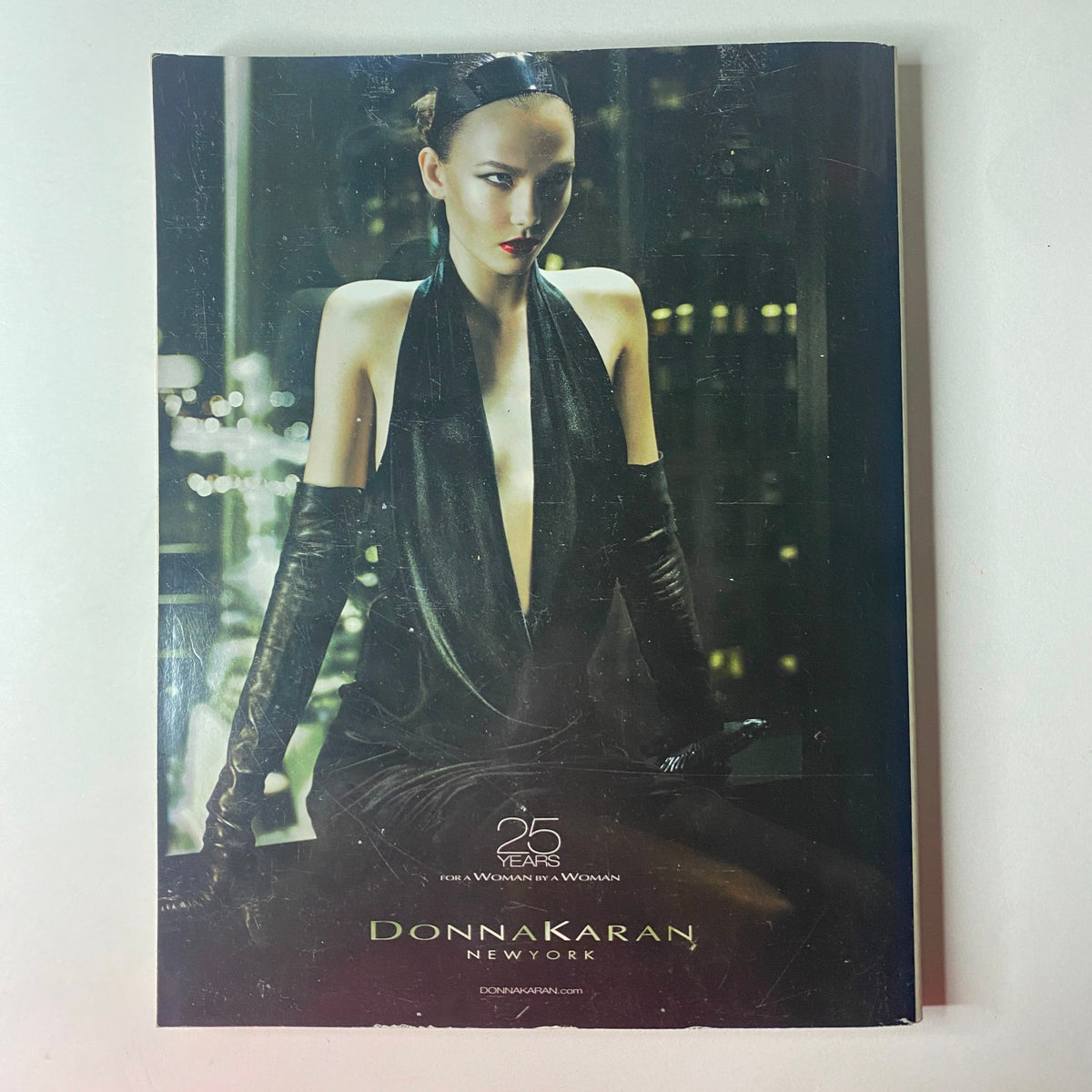 Donna Karan advertisement from Vogue British Magazine September 2010. Features a high-fashion model in a dramatic black outfit, symbolizing luxury and sophistication.