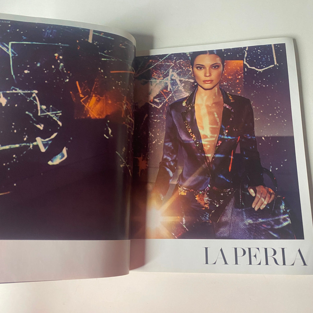 An advertisement spread from Vogue British Magazine January 2017, featuring a La Perla fashion campaign, showcasing elegant designs and artistry.