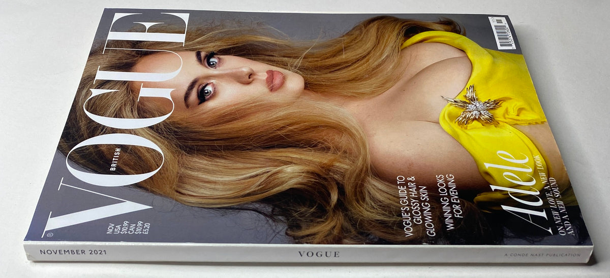 Close-up view of the Vogue British Magazine November 2021 with Adele on the cover, highlighting her stunning blonde hair and couture styling, ideal for fashion enthusiasts.