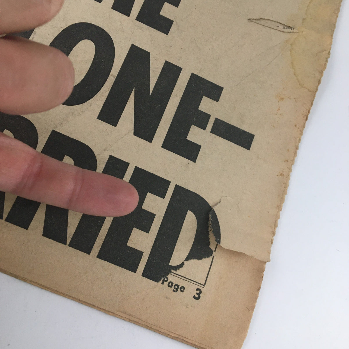 Close-up of the edge of the National Enquirer Newspaper June 20 1965, showing the phrase 'I'M MARRIED' adjacent to wear and tear details.