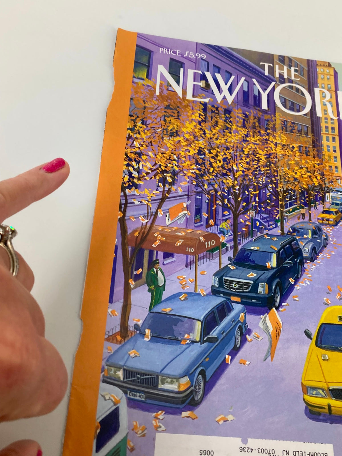 Detailed view of the wear on The New Yorker November 7, 2011, cover 'Open Season' by Bruce McCall, highlighting the colorful illustration and visible imperfections.