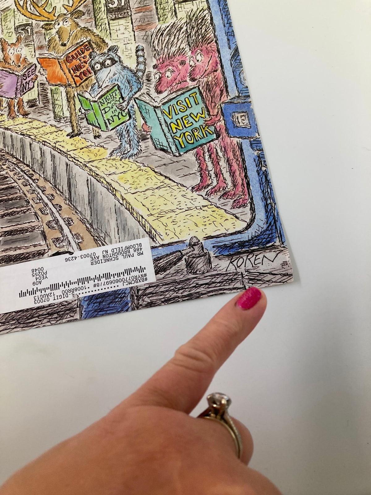 Close-up of the signature of Edward Koren on the cover of The New Yorker, April 4, 2011, showcasing unique urban-themed art.