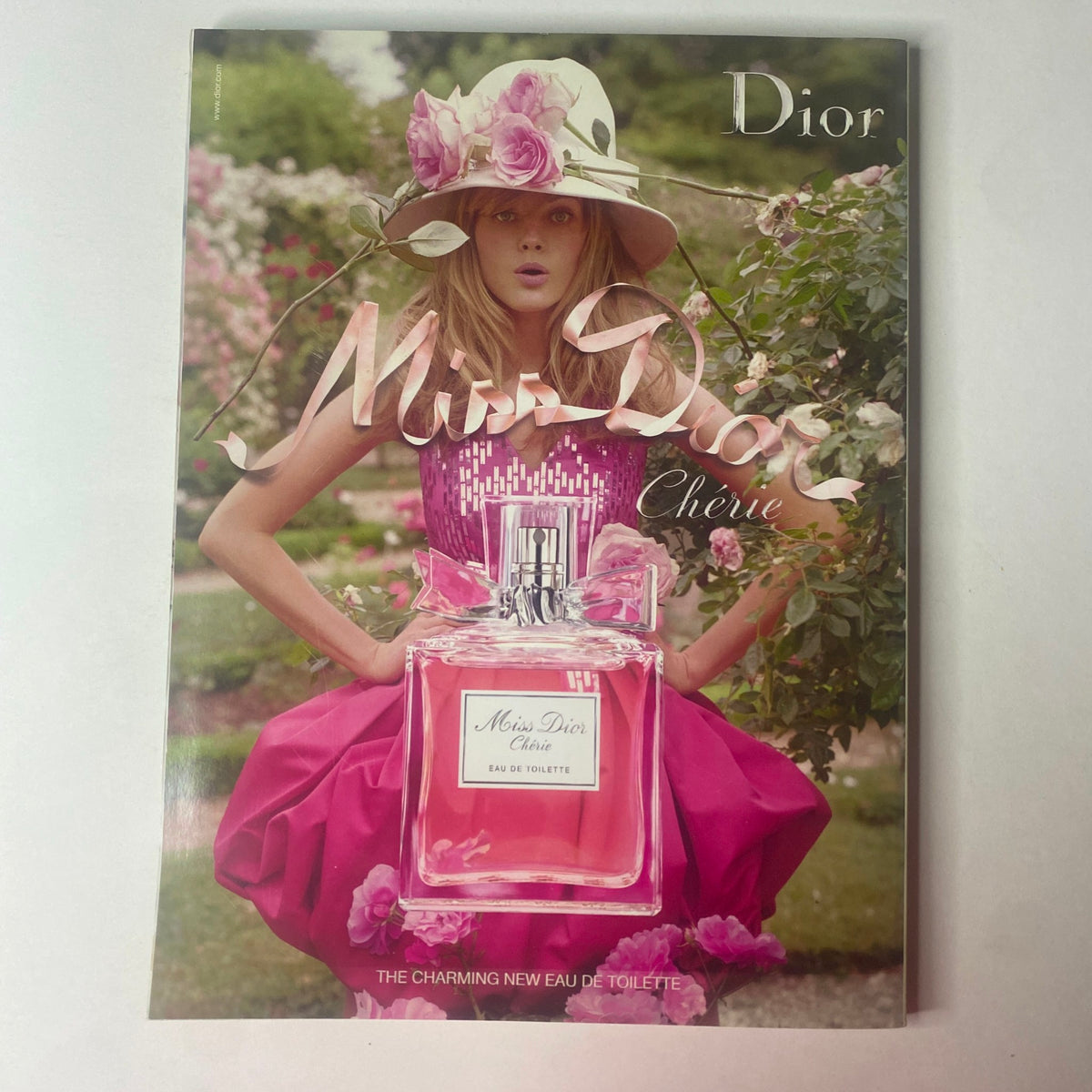 Vogue Australia Magazine April 2010 including an advertisement for Miss Dior Chérie perfume, featuring a model in a pink dress with flowers in a garden. A perfect addition for those interested in fashion and beauty.