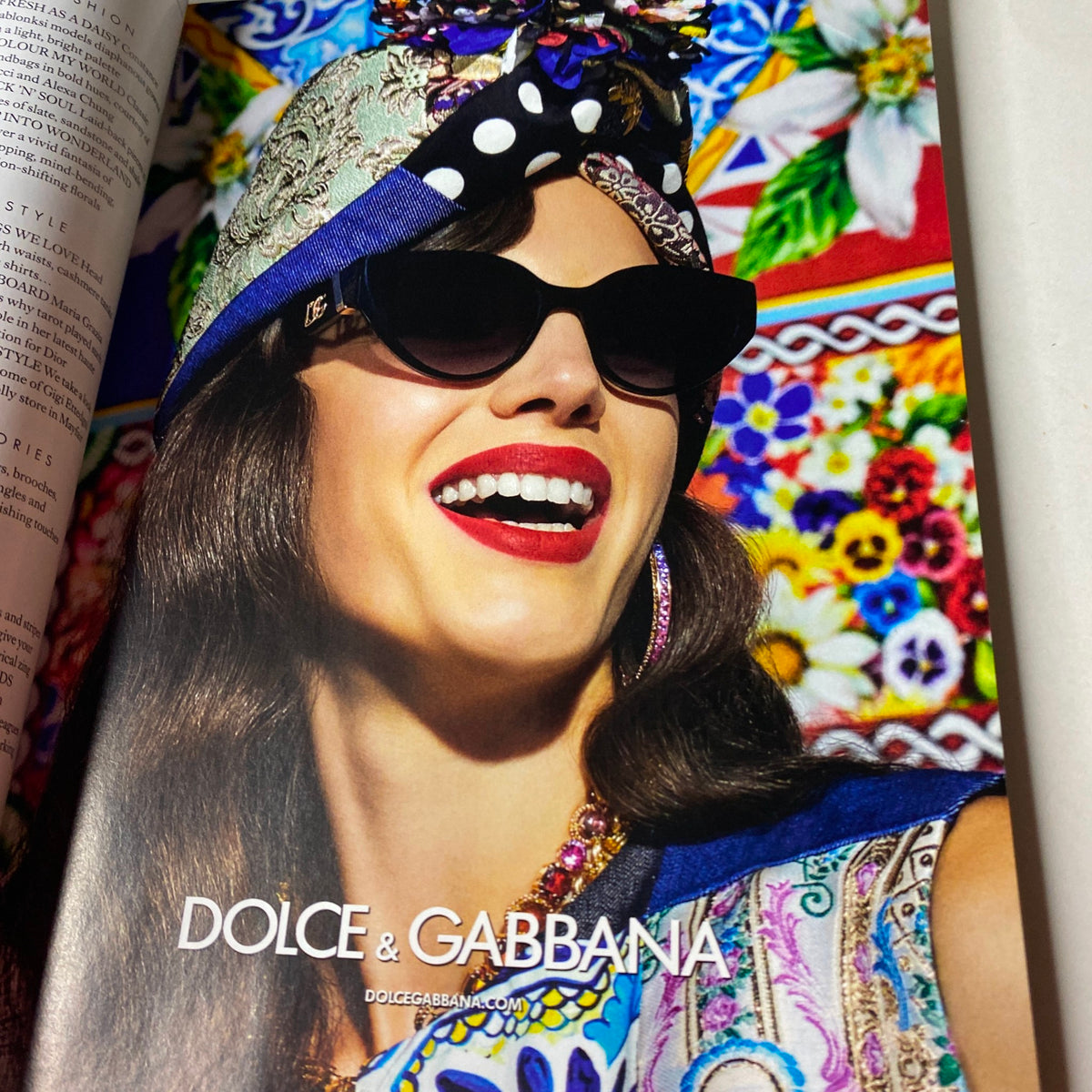 Colorful and artistic advertisement from Dolce & Gabbana in Harper's Bazaar May 2021, featuring bold fashion and vibrant patterns.