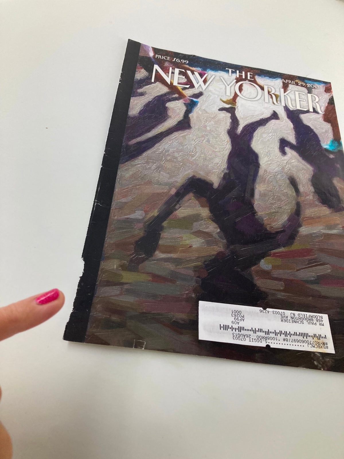 Close-up view of The New Yorker cover from April 29, 2013, titled 'Shadow Over Boston' by Eric Drooker, highlighting details of the artwork and a protective label.