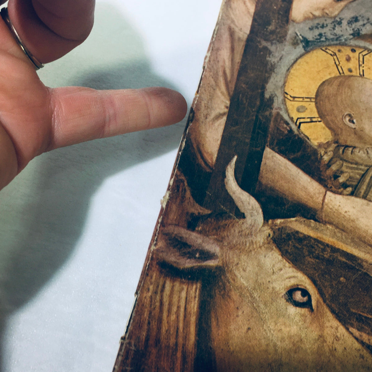 Close-up view of the cover of VTG Life Magazine December 27 1948 highlighting the artwork depicting the infant Christ, with visible wear and a hand pointing at the image.