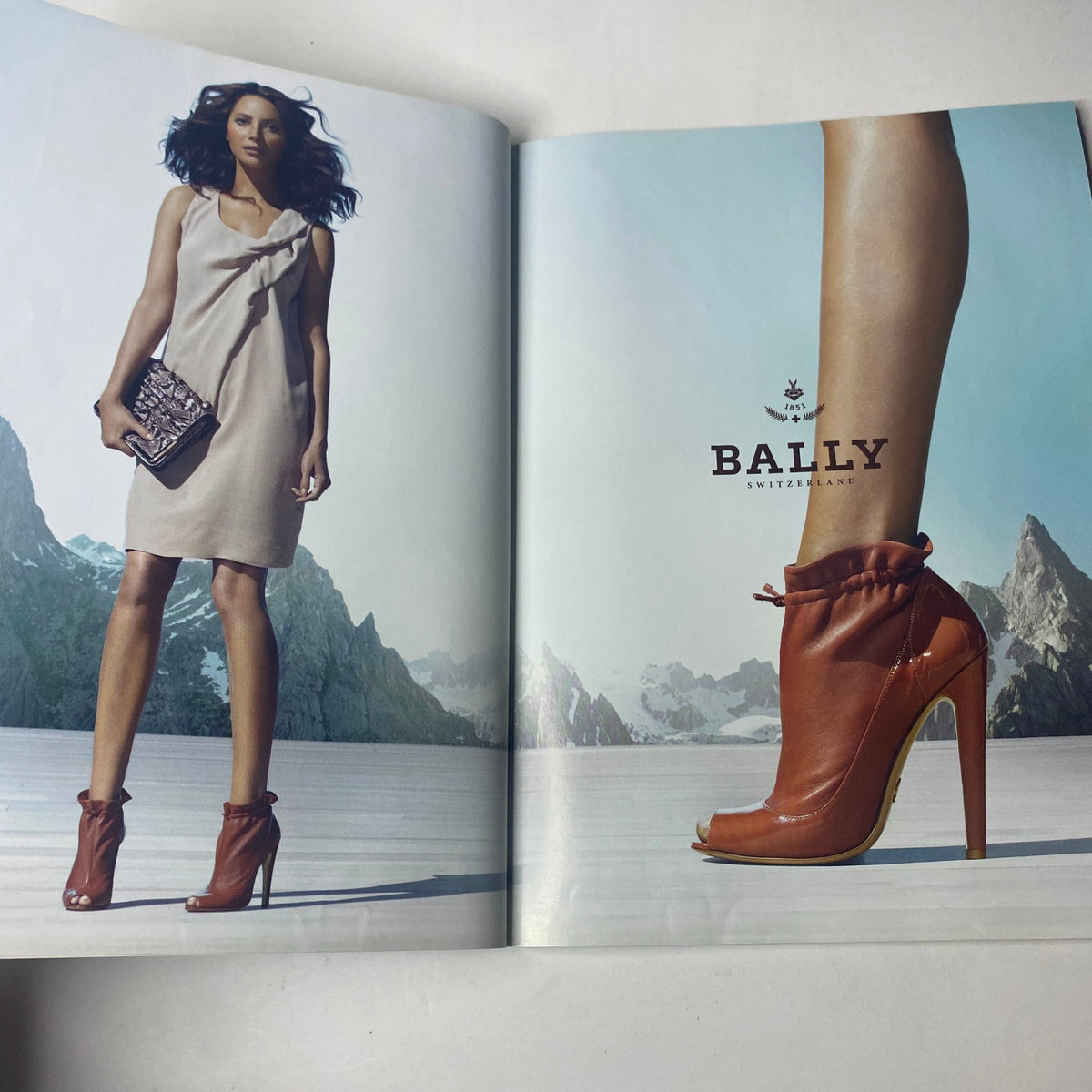 Fashion advertisement page from Harper's Bazaar UK Magazine February 2010 featuring a designer dress and shoes, promoting stylish looks aligned with the magazine's fashion themes.