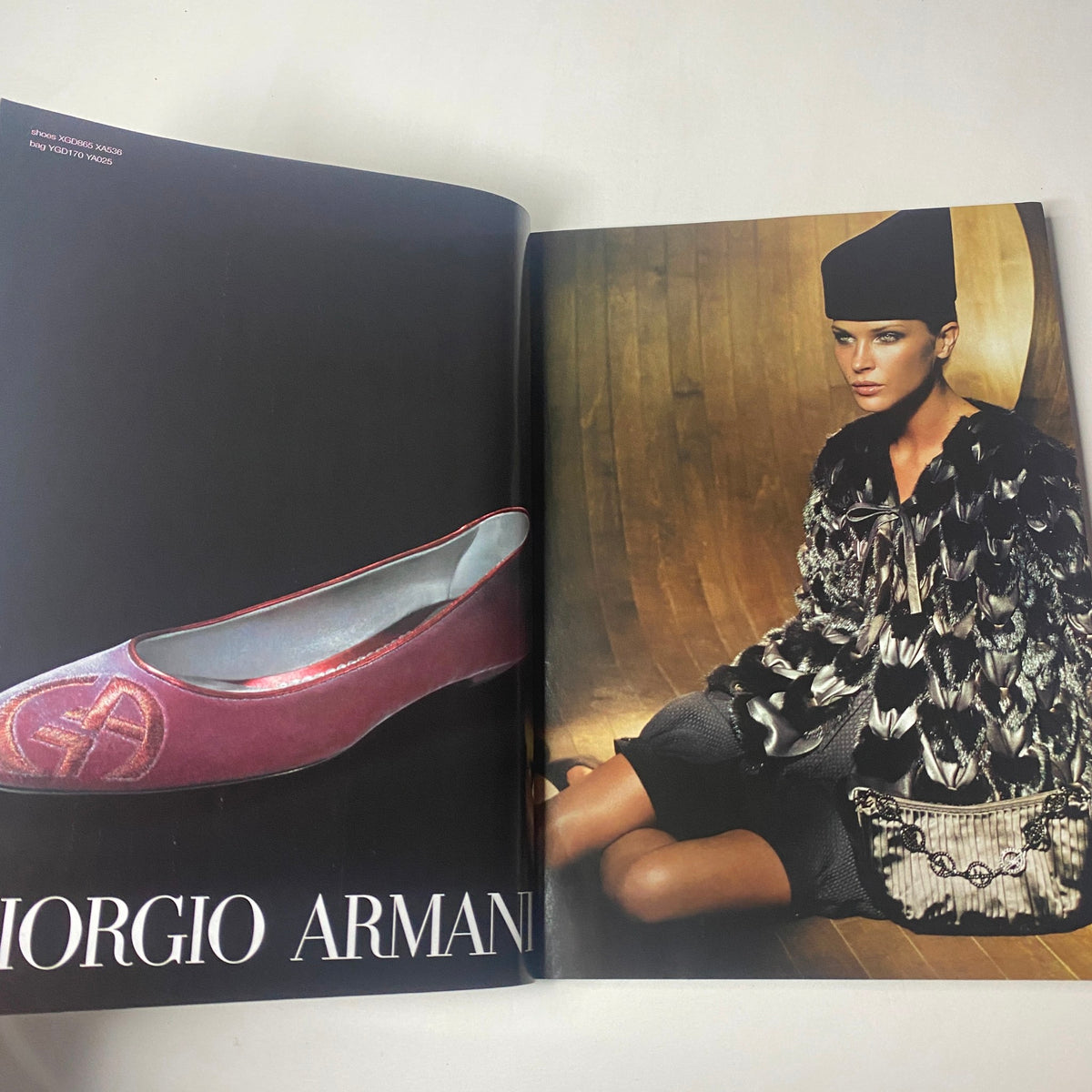 Fashion editorial page from Harper's Bazaar Magazine October 2005 featuring a Giorgio Armani fashion piece with an elegant model showcasing luxury style.