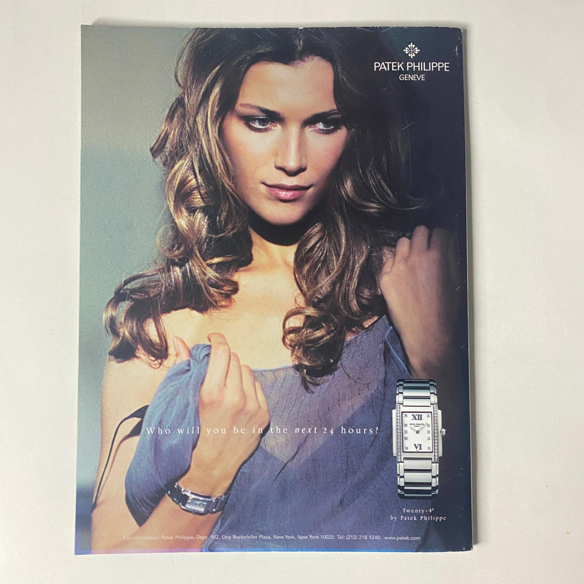 Patek Philippe advertisement displaying a glamorous model with elegant wristwatch and long, styled hair, featured in Harper's Bazaar Magazine January 2005 Scarlett Johansson Cover.