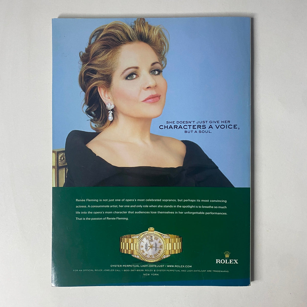 Back cover of Harper's Bazaar Magazine February 2005 featuring actress Rhonda Fleming, promoting her impactful roles in character development, paired with a luxury Rolex advertisement, underscoring elegance.