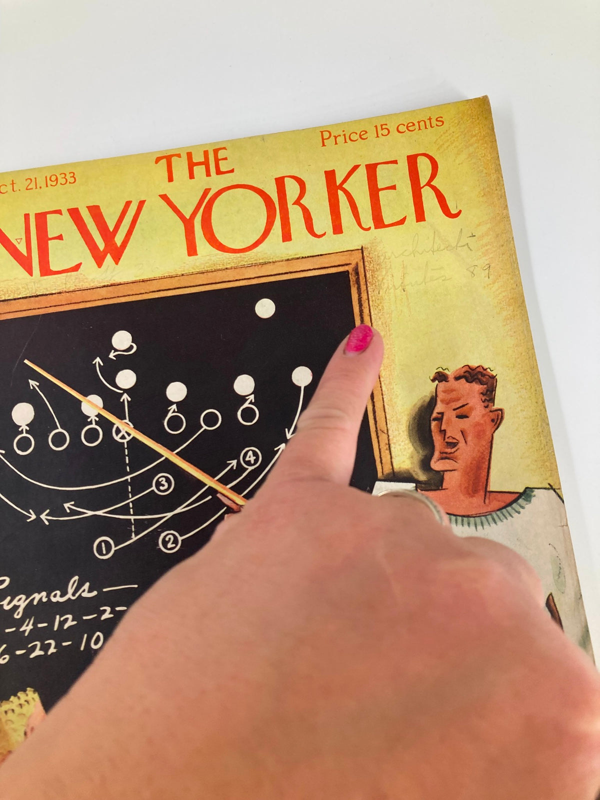 Close-up of The New Yorker Magazine October 21, 1933 cover, showing a finger pointing at the title and football strategy illustration by Harry Brown.