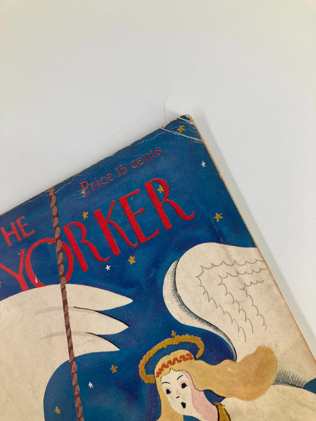 Cover detail of The New Yorker Magazine December 22 1934 featuring the title in red and artwork depicting an angel, by Arnold Hall.