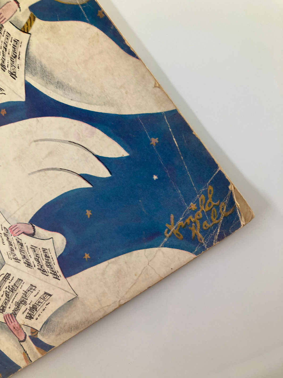 Close-up view of The New Yorker Magazine cover December 22 1934, showcasing the signature of artist Arnold Hall along with angel imagery.