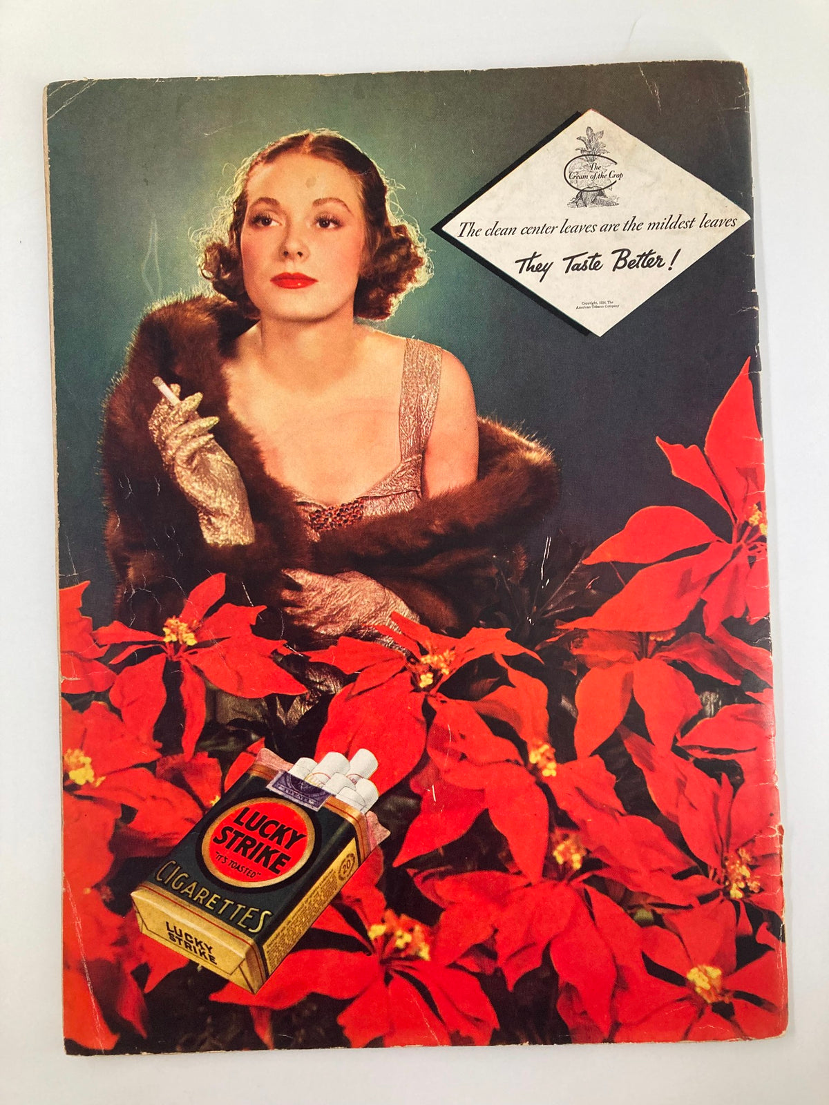 Cover of The New Yorker Magazine December 22 1934, depicting a glamorous woman in a glittering dress surrounded by vibrant red poinsettias, promoting Lucky Strike cigarettes, capturing the opulent style of the 1930s.
