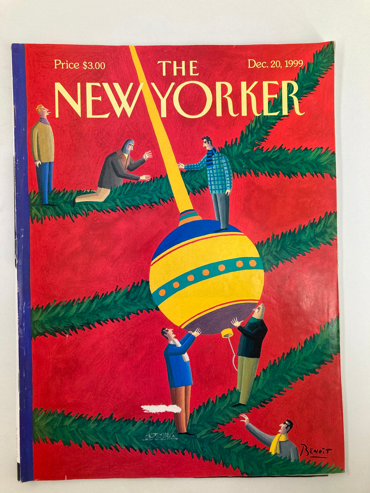 Cover of The New Yorker Magazine December 20, 1999 featuring an artistic installation by Benoit van Innis, depicting figures hanging a large ornament on a tree with a vibrant red background.