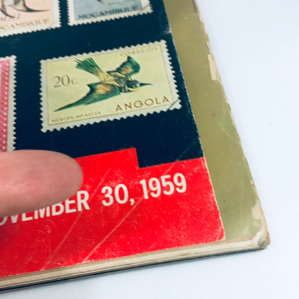 Highlighted detail of the VTG Life Magazine dated November 30, 1959, showing the date and a stamp from Angola, emphasizing its significance in the cover story 'Rainbow of Stamps'.