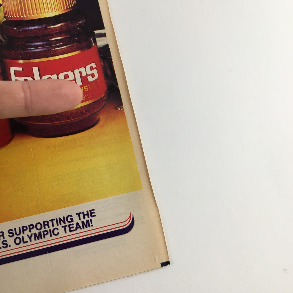 Close-up of the 1984 Folgers Coffee U.S. Olympic Team Circular Coupon Advertisement highlighting Folgers products with promotional text.