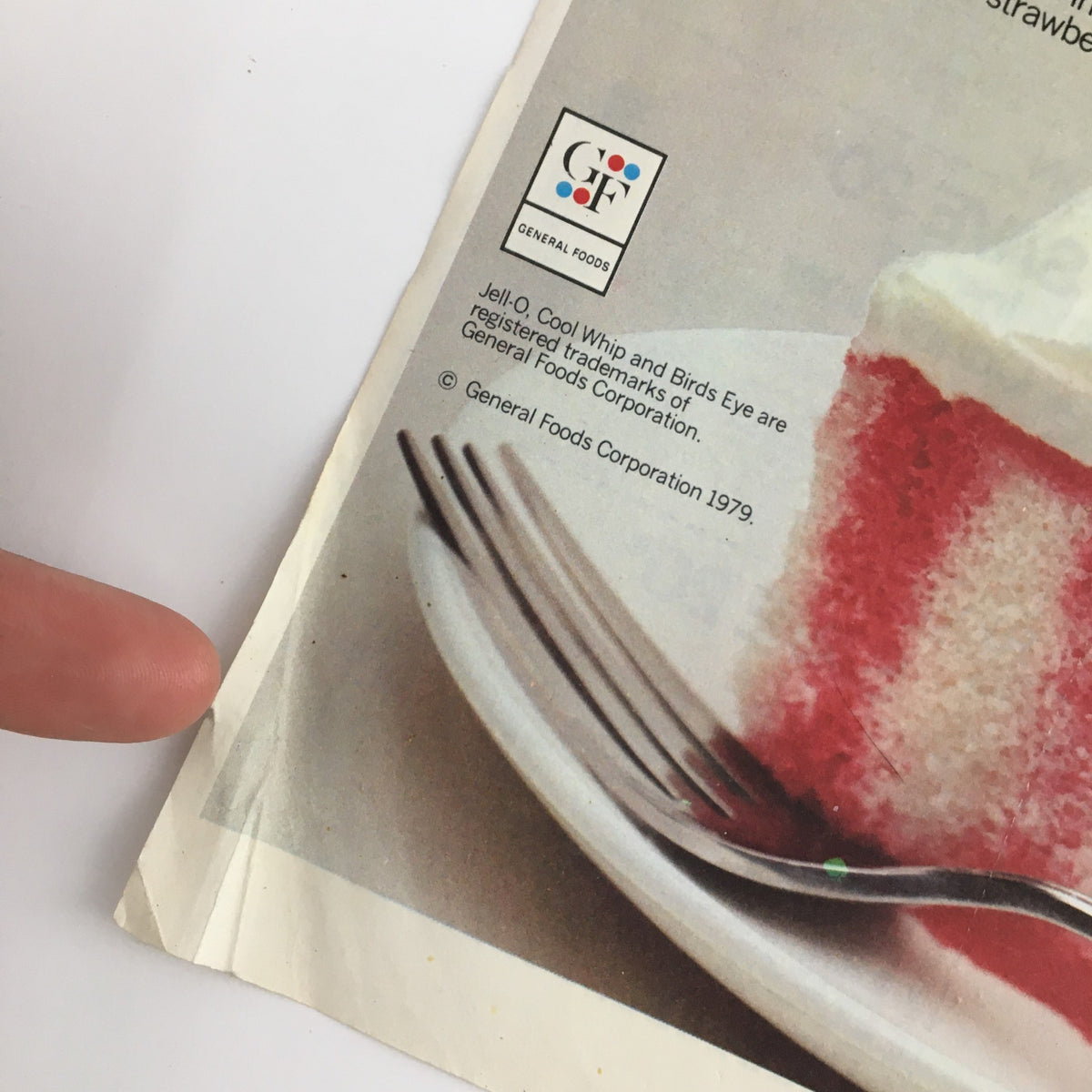 Close-up view of the 1979 Jell-O Brand Gelatin Rainbow Cake Coupon Advertisement showing details and branding information at the bottom.