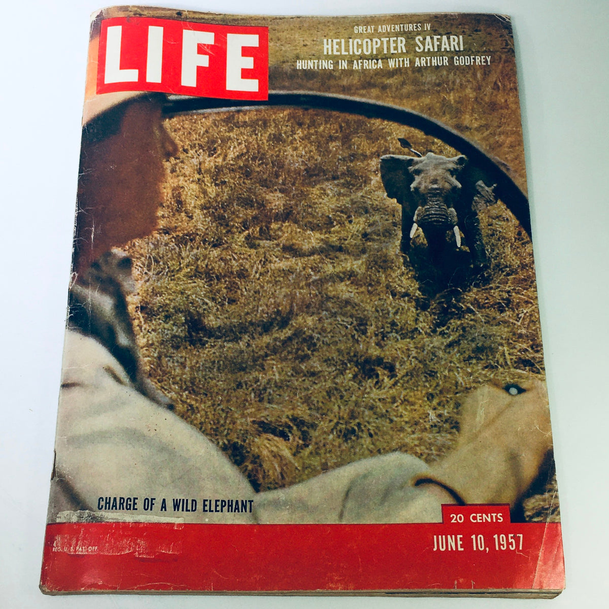 Cover of the VTG Life Magazine dated June 10, 1957, featuring 'Hunting in Africa with Arthur Godfrey'. The image showcases a wild elephant charging, with an exciting depiction of a helicopter safari adventure, inviting readers to explore the allure of 1950s exploration.