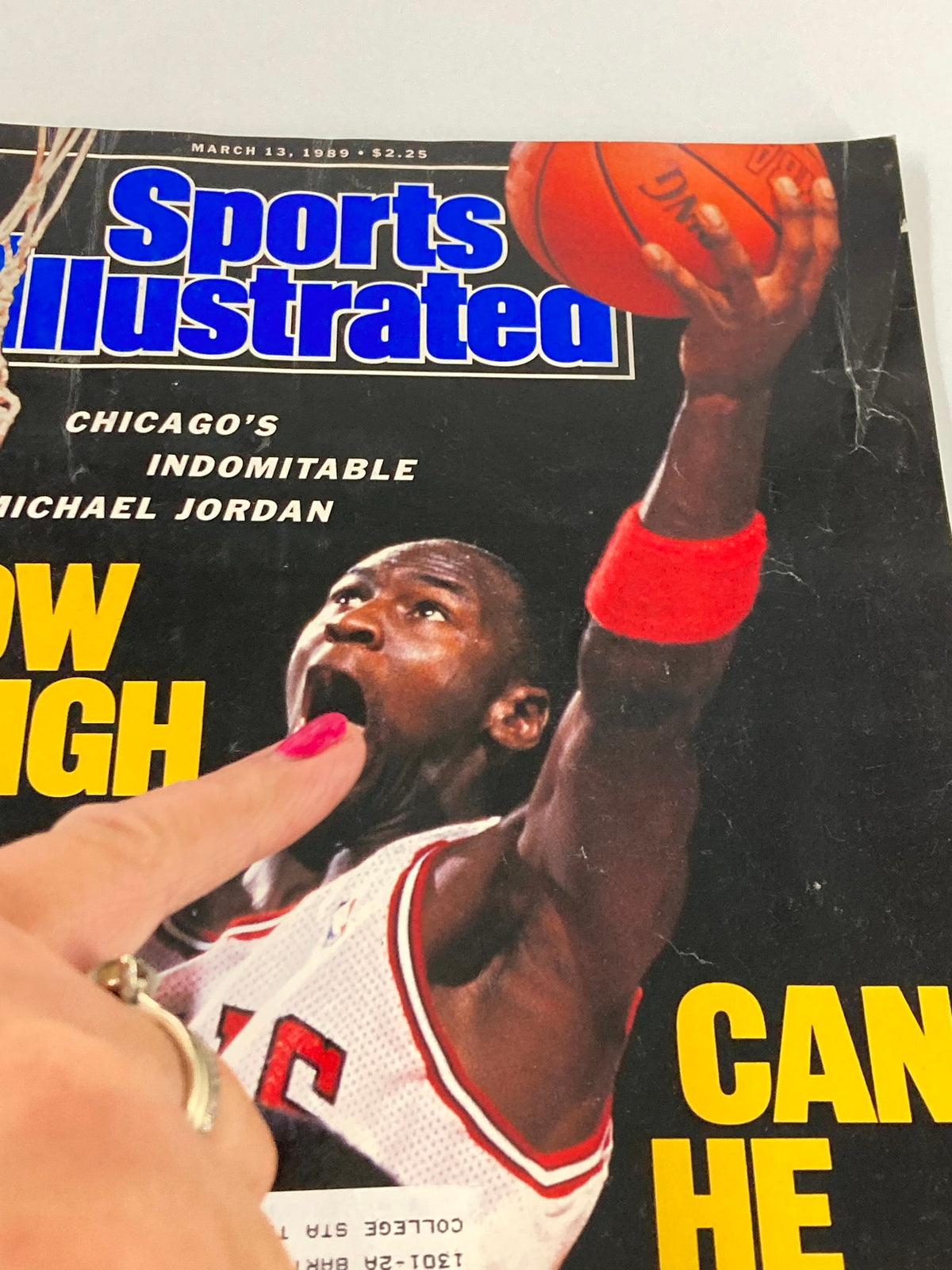 Close-up of Sports Illustrated magazine cover dated March 13, 1989, with Michael Jordan of the Chicago Bulls. The bold text asks 'HOW HIGH CAN HE FLY?' with Jordan making an impressive basketball play.